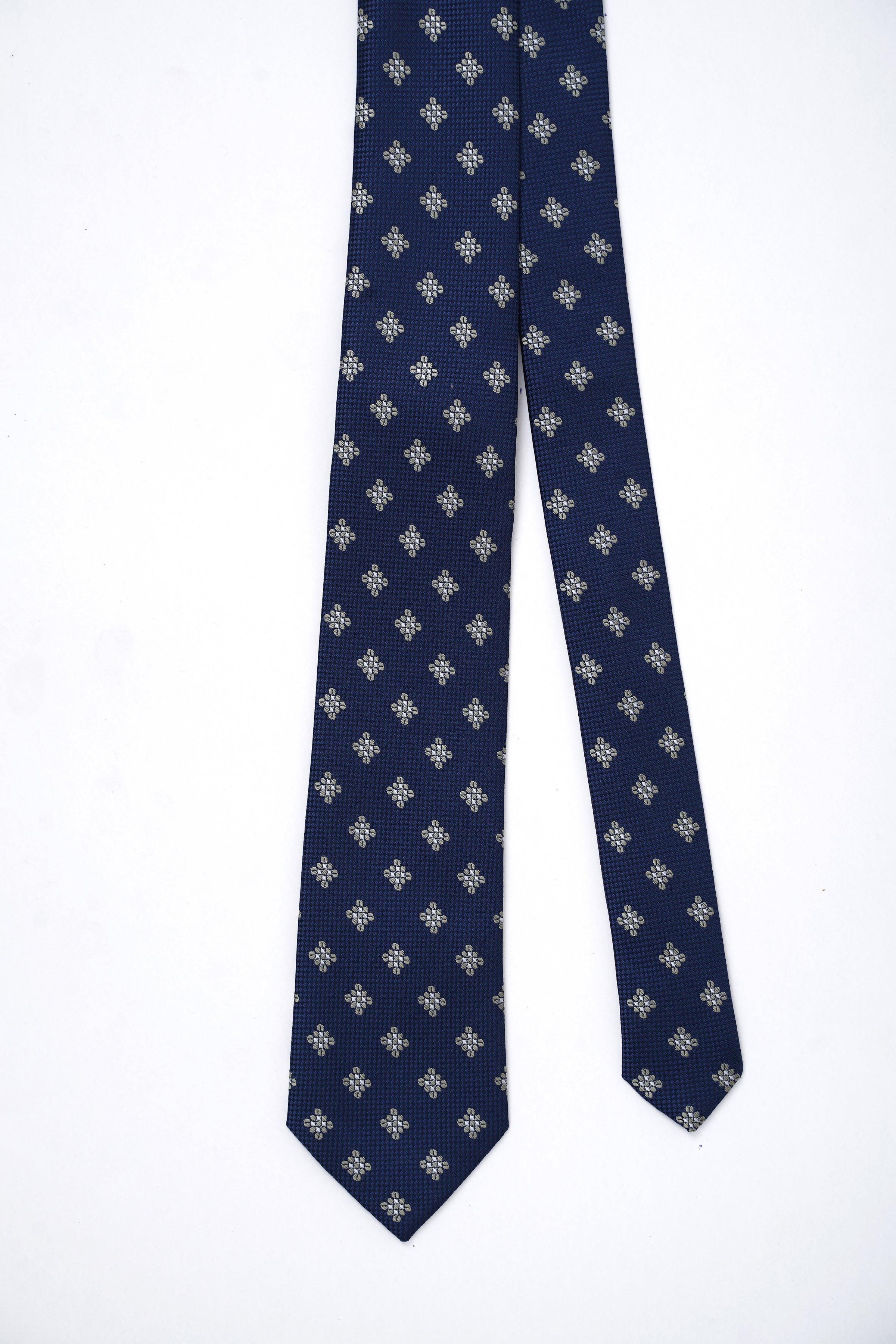 Blue poly silk tie laid flat, showing repeating small light-gray floral pattern