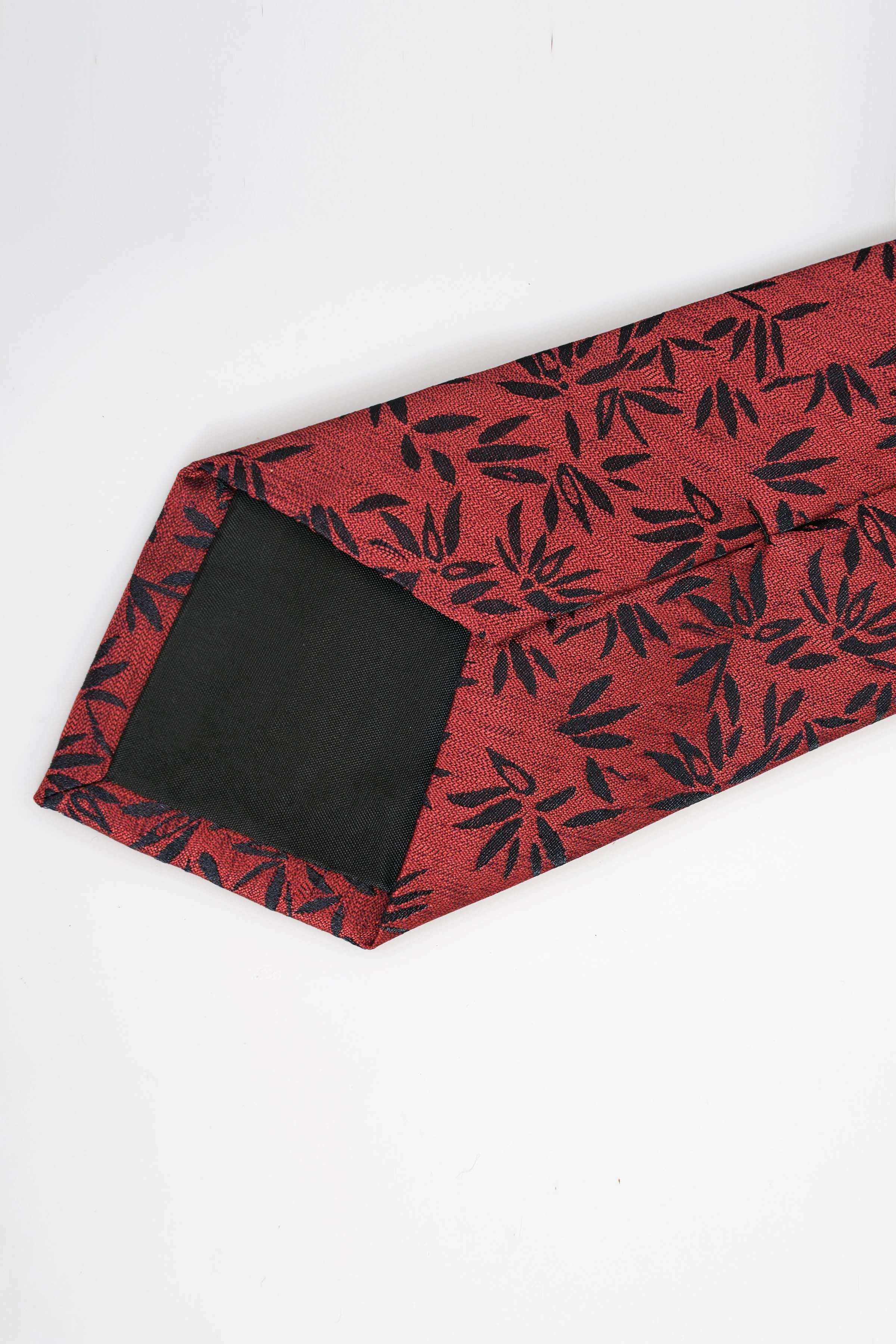 Red tie with dark leaf print, wider keeper section and pointed tip