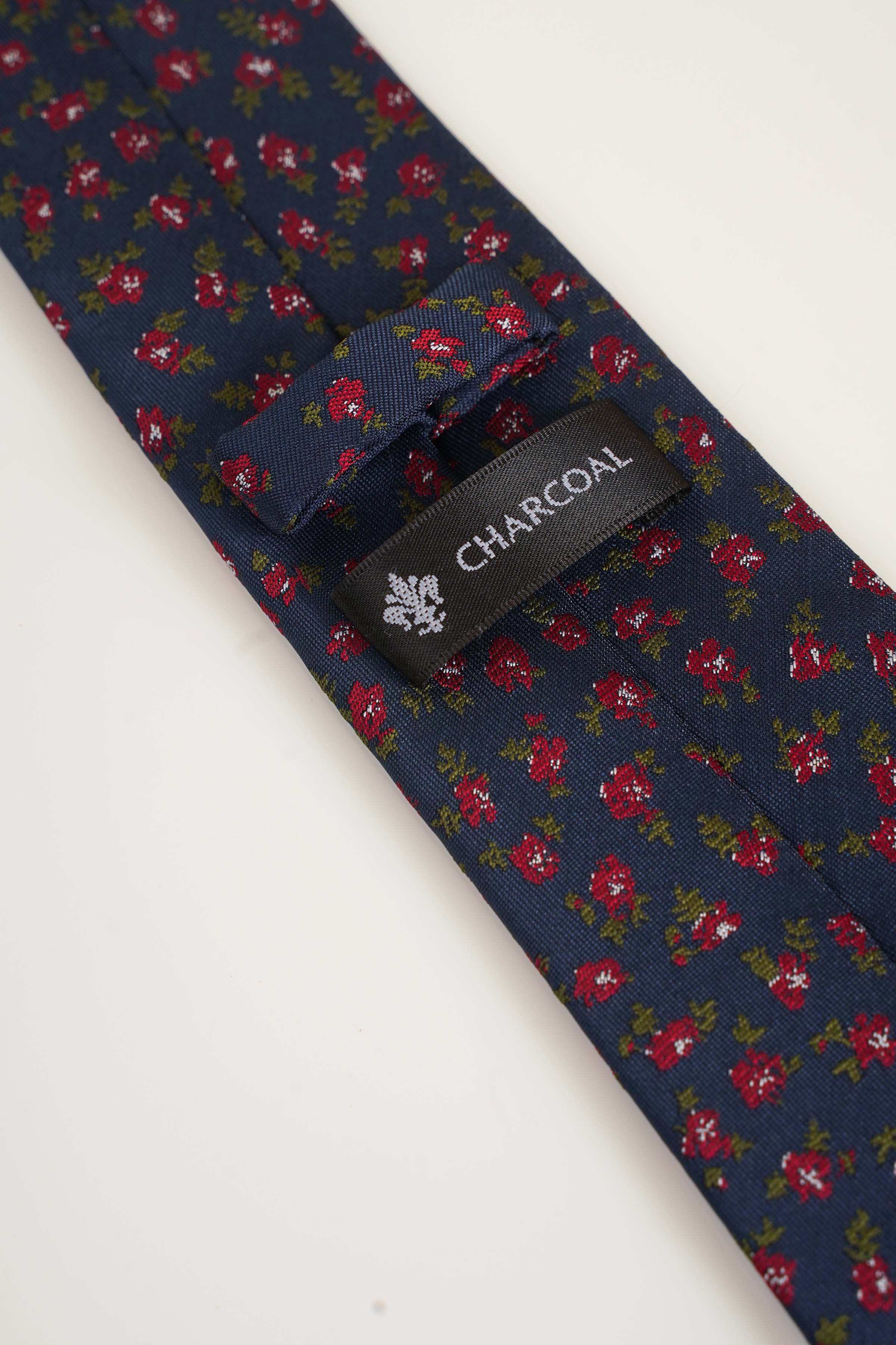 Navy poly silk tie with floral pattern and 'CHARCOAL' label near blade