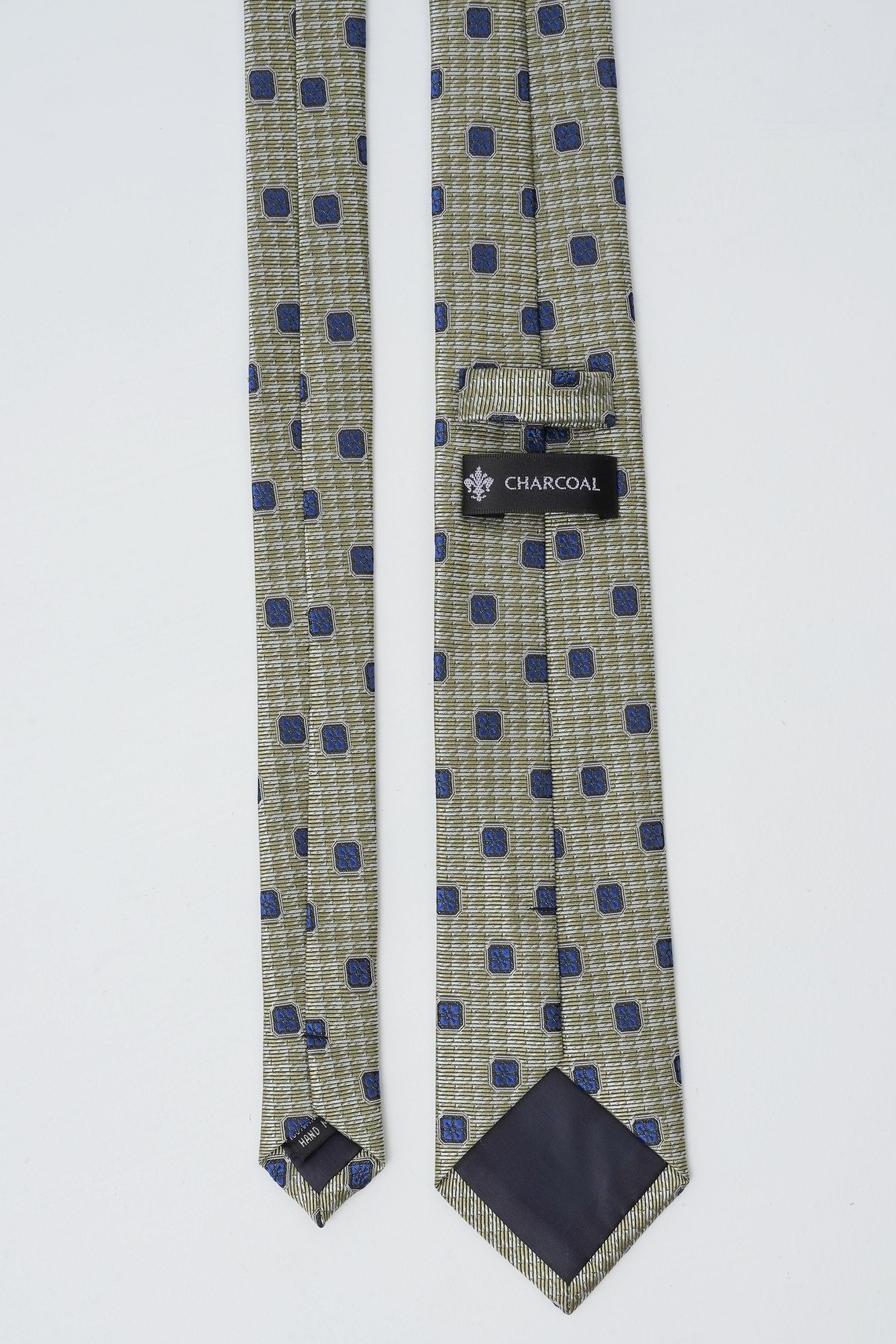 Poly silk tie in light green with navy square pattern, hanging with label