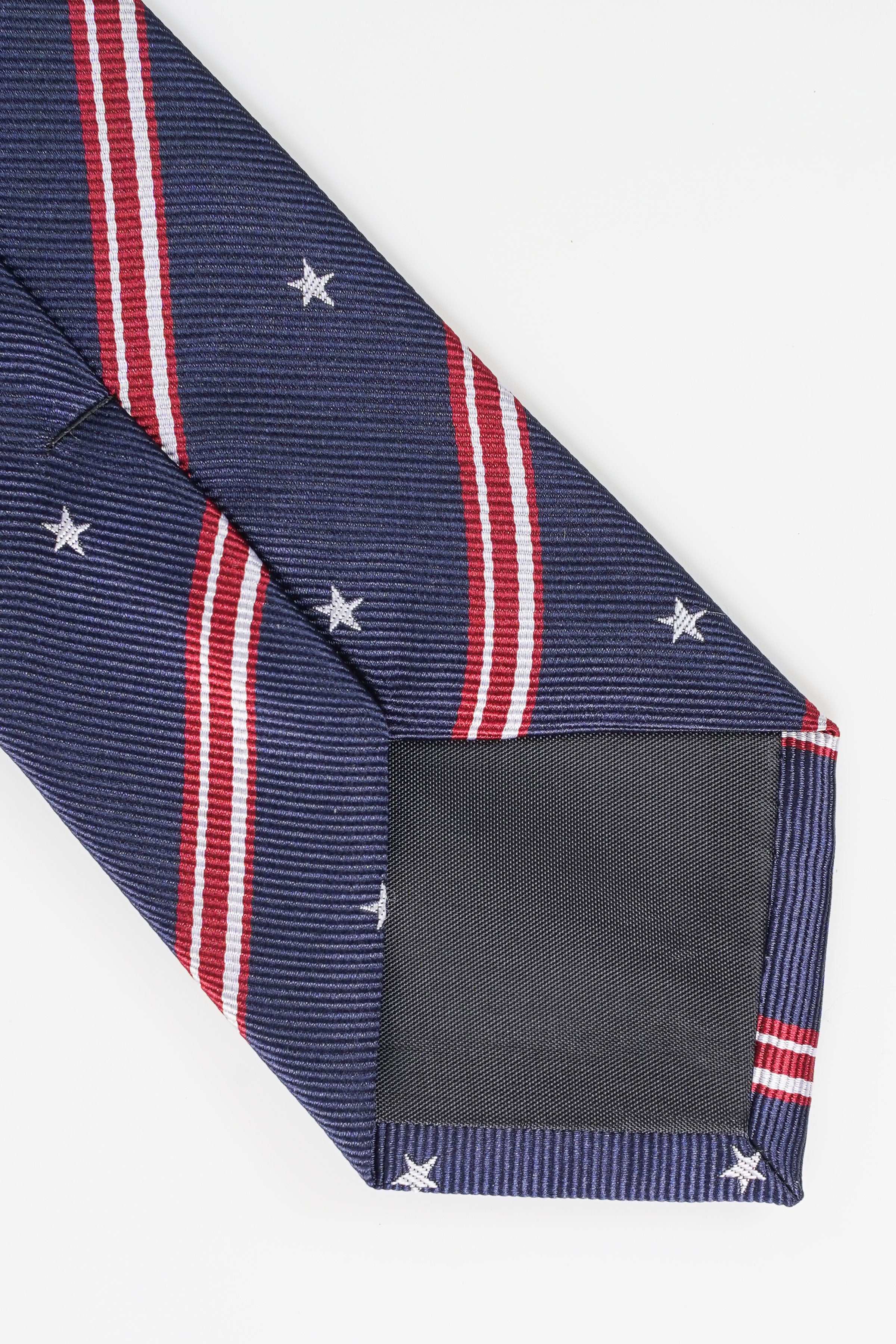 Navy poly silk tie with striped pattern, folded end, and star accents