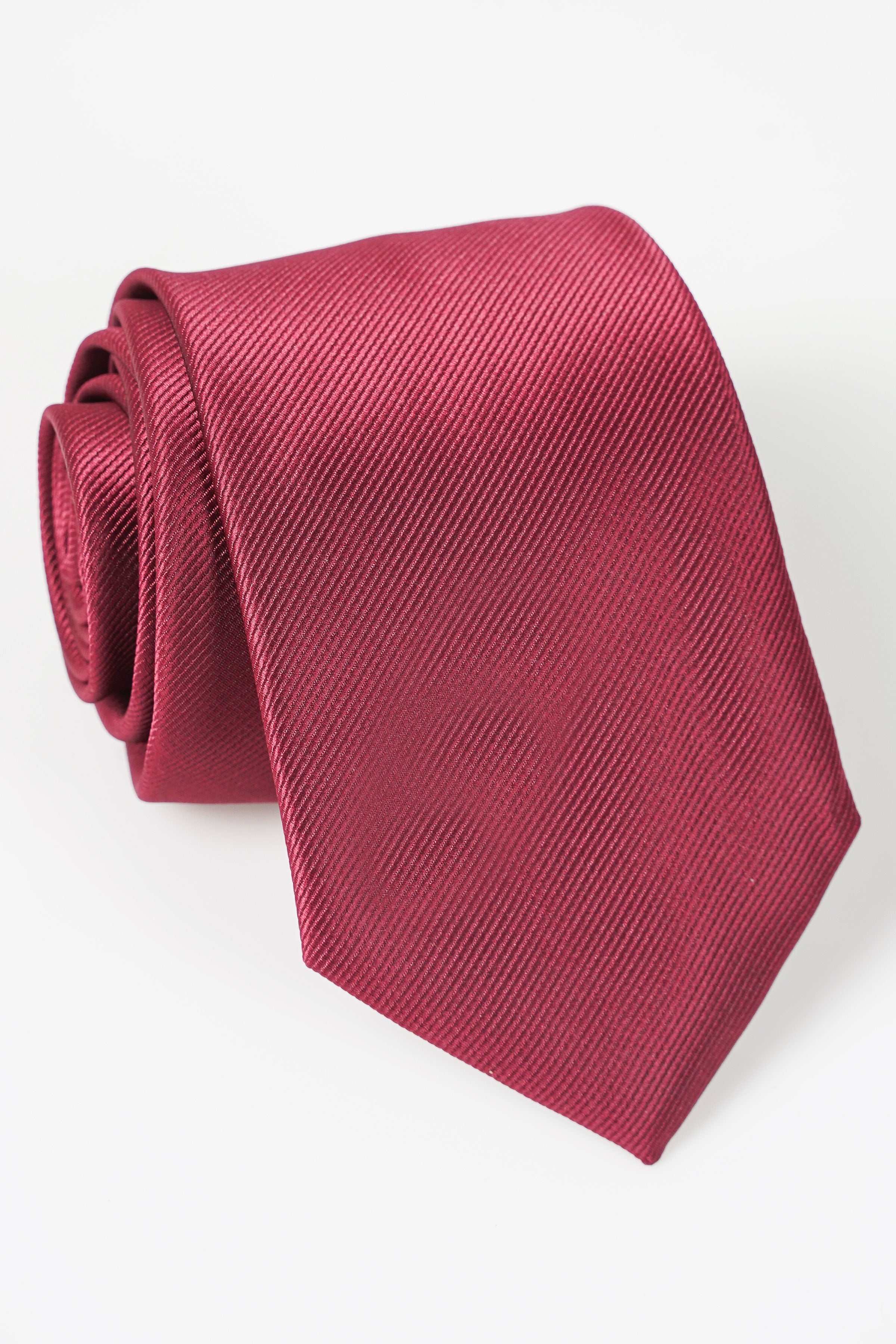 Maroon textured tie with fine diagonal weave, folded at the knot end