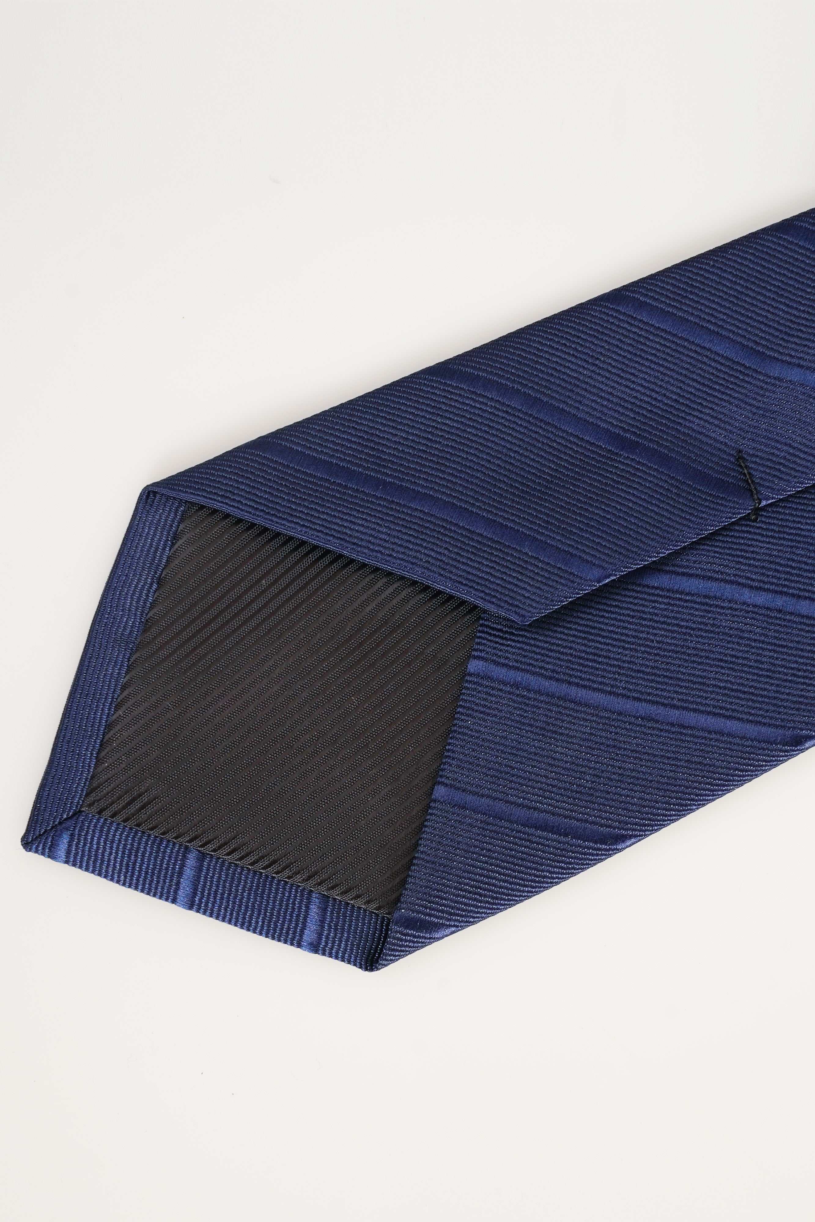 Dark blue poly-silk tie with diagonal stripes, folded tip detail