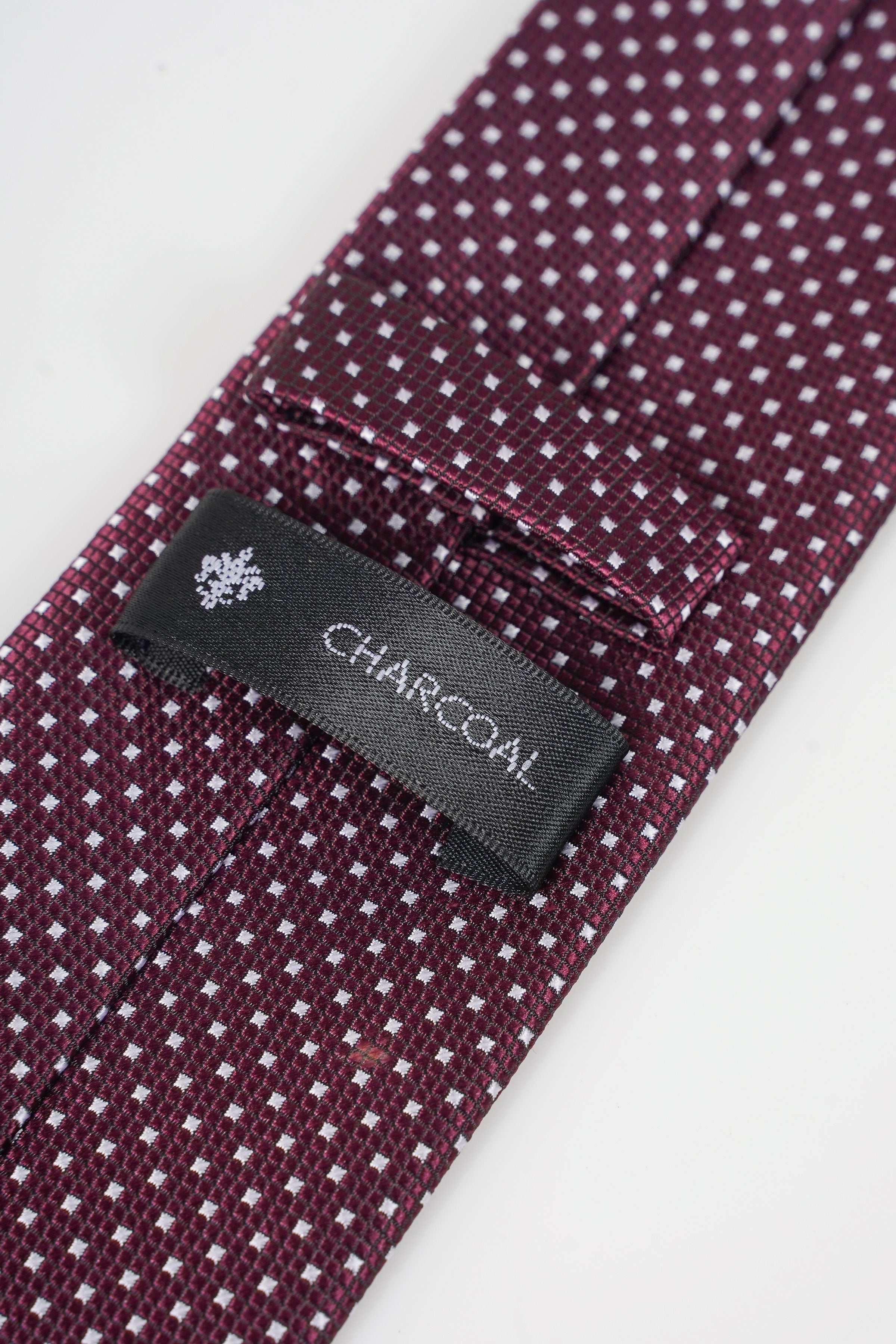 Poly silk tie with maroon fabric and white dot pattern; CHARCOAL label
