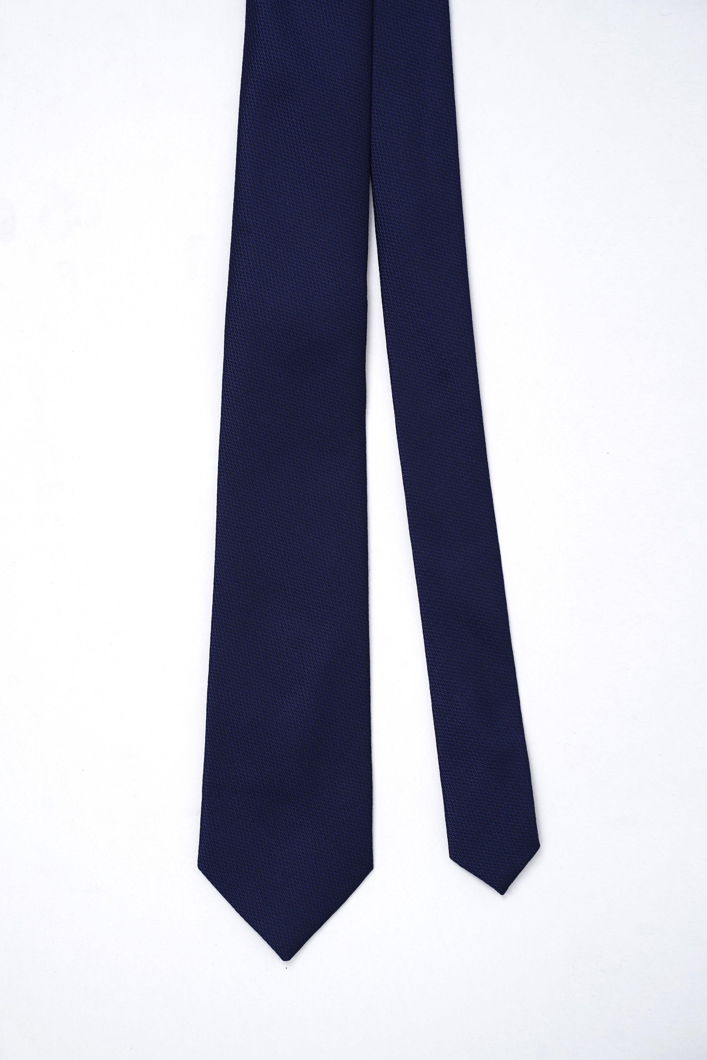 Dark navy poly silk neckties displayed side by side with pointed ends