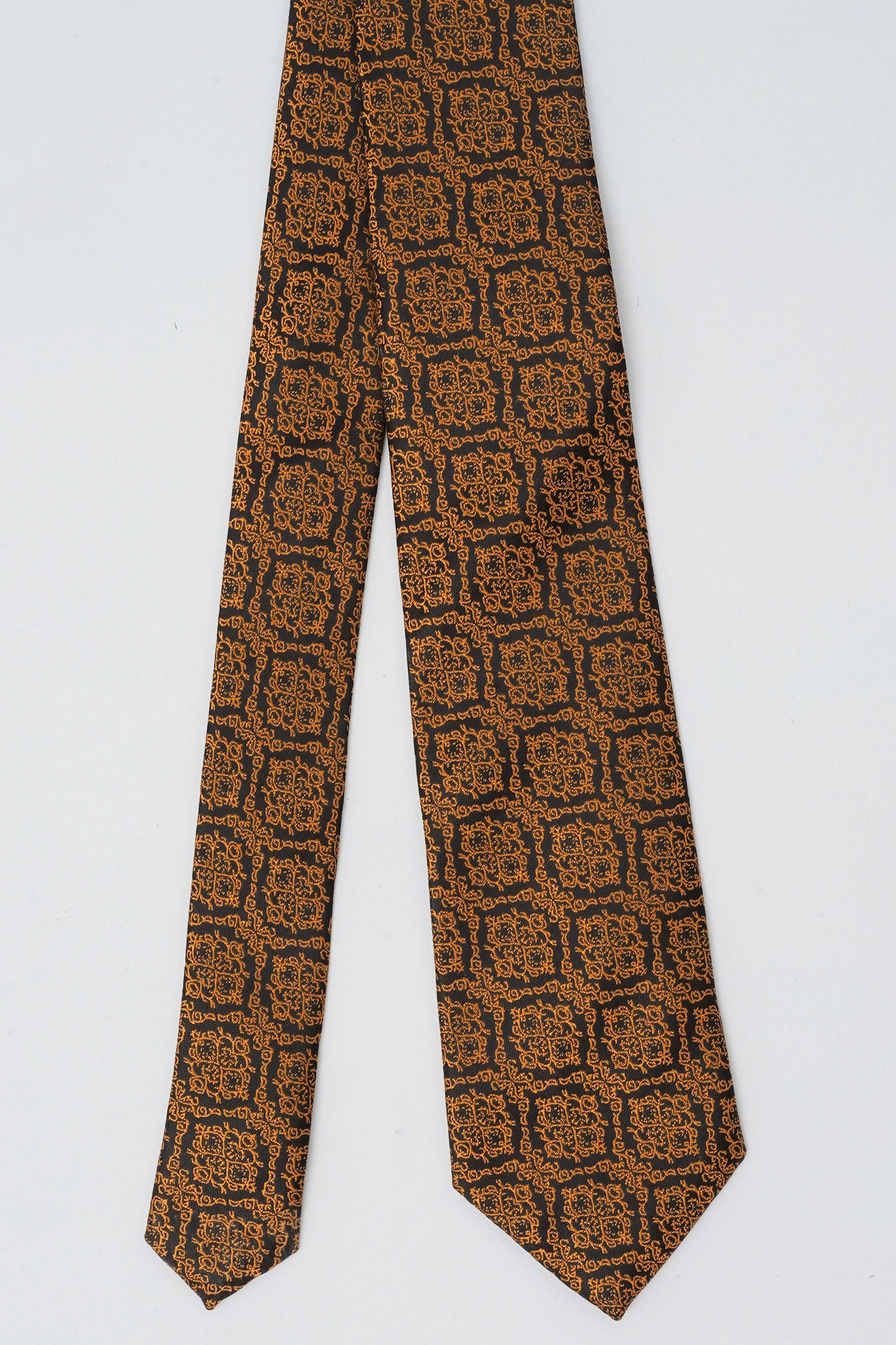 Poly silk tie laid flat, brown and navy geometric print