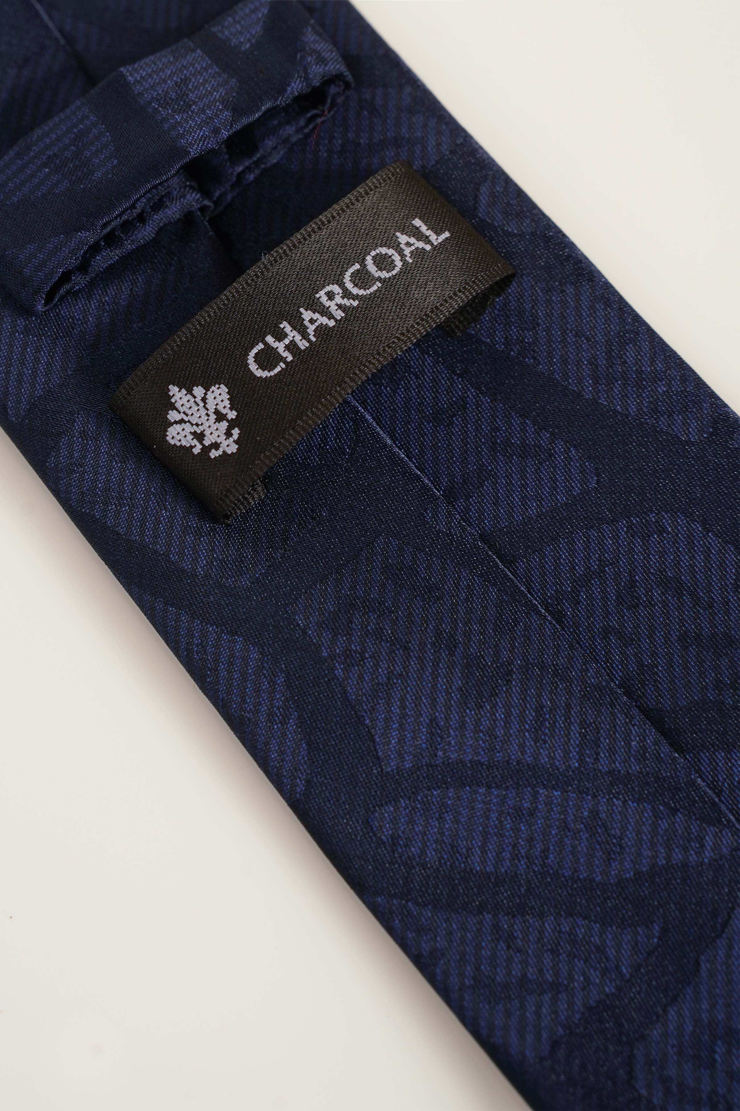 Navy poly silk tie with CHARCOL label and leaf pattern
