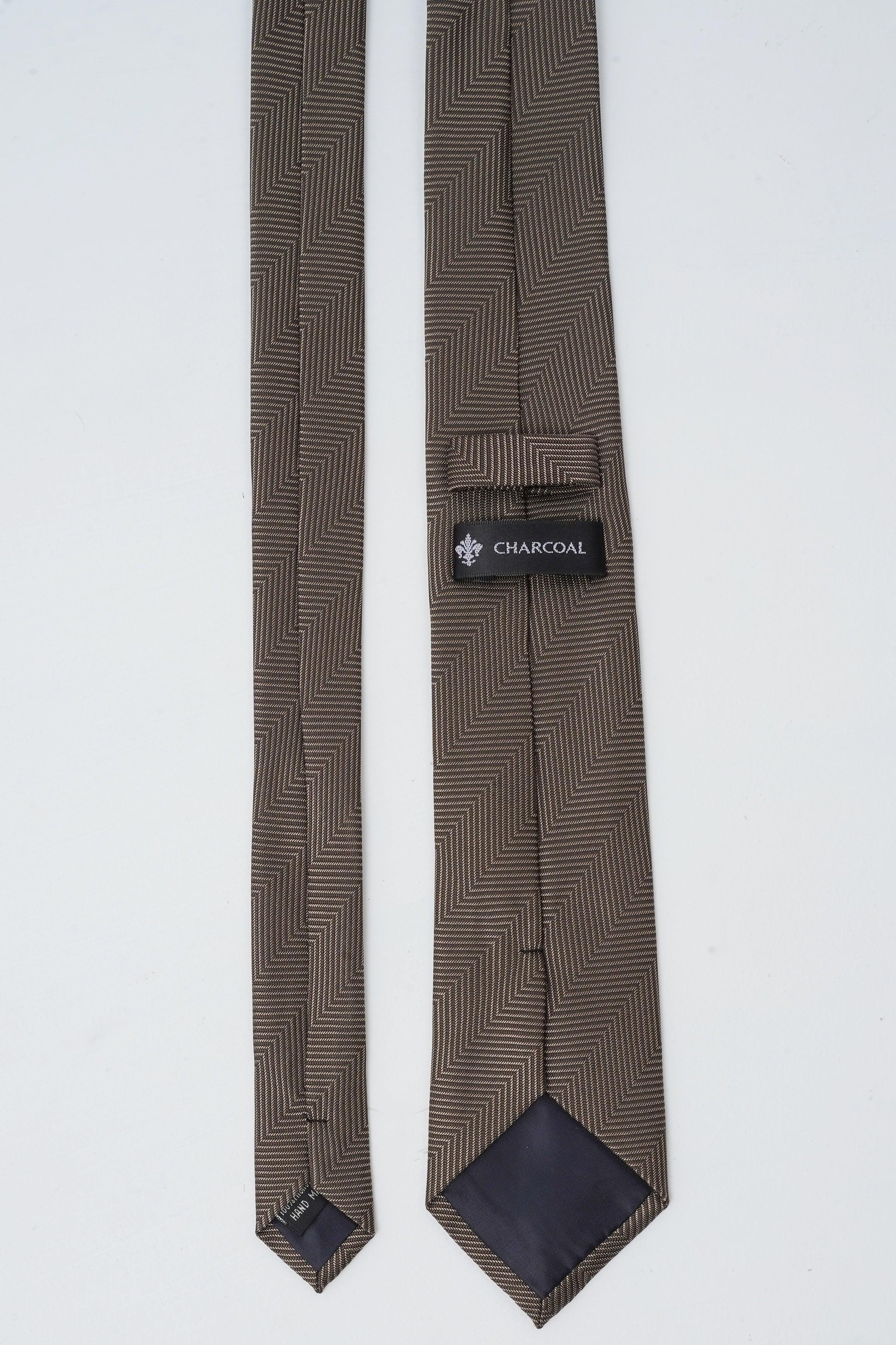 Poly silk tie in charcoal zigzag pattern, brand label at center.