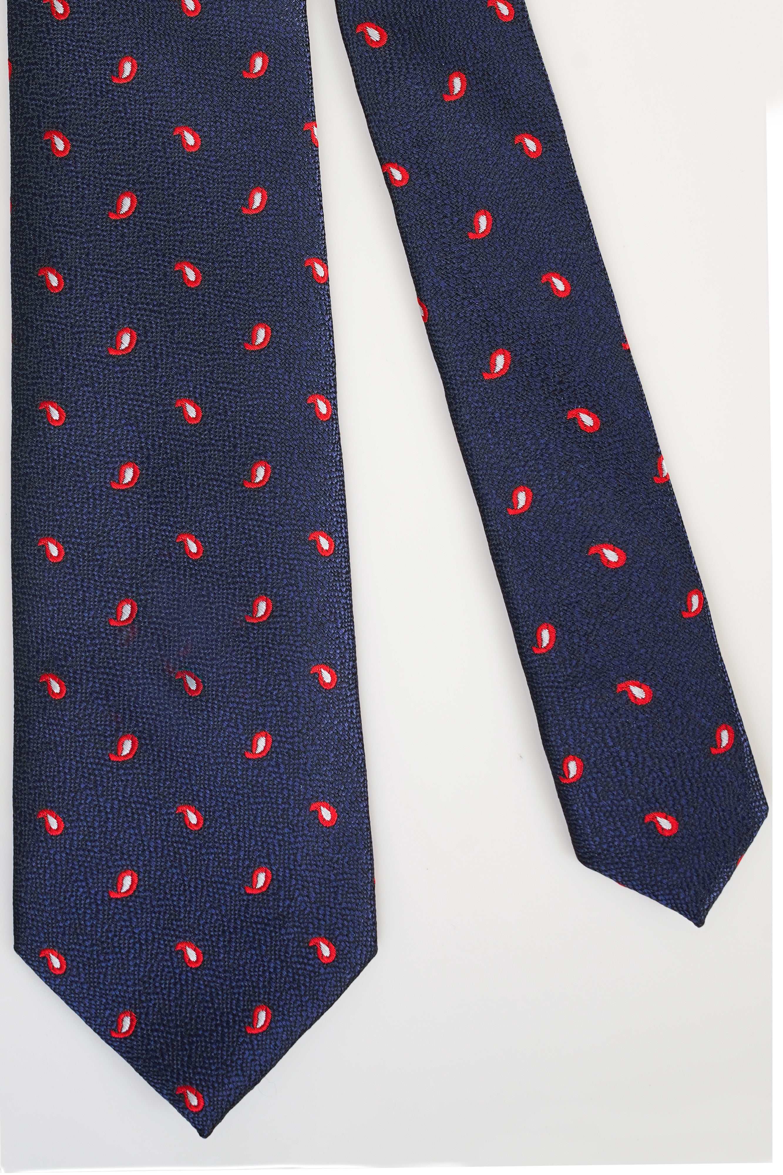 Navy poly silk tie with small red paisley pattern.