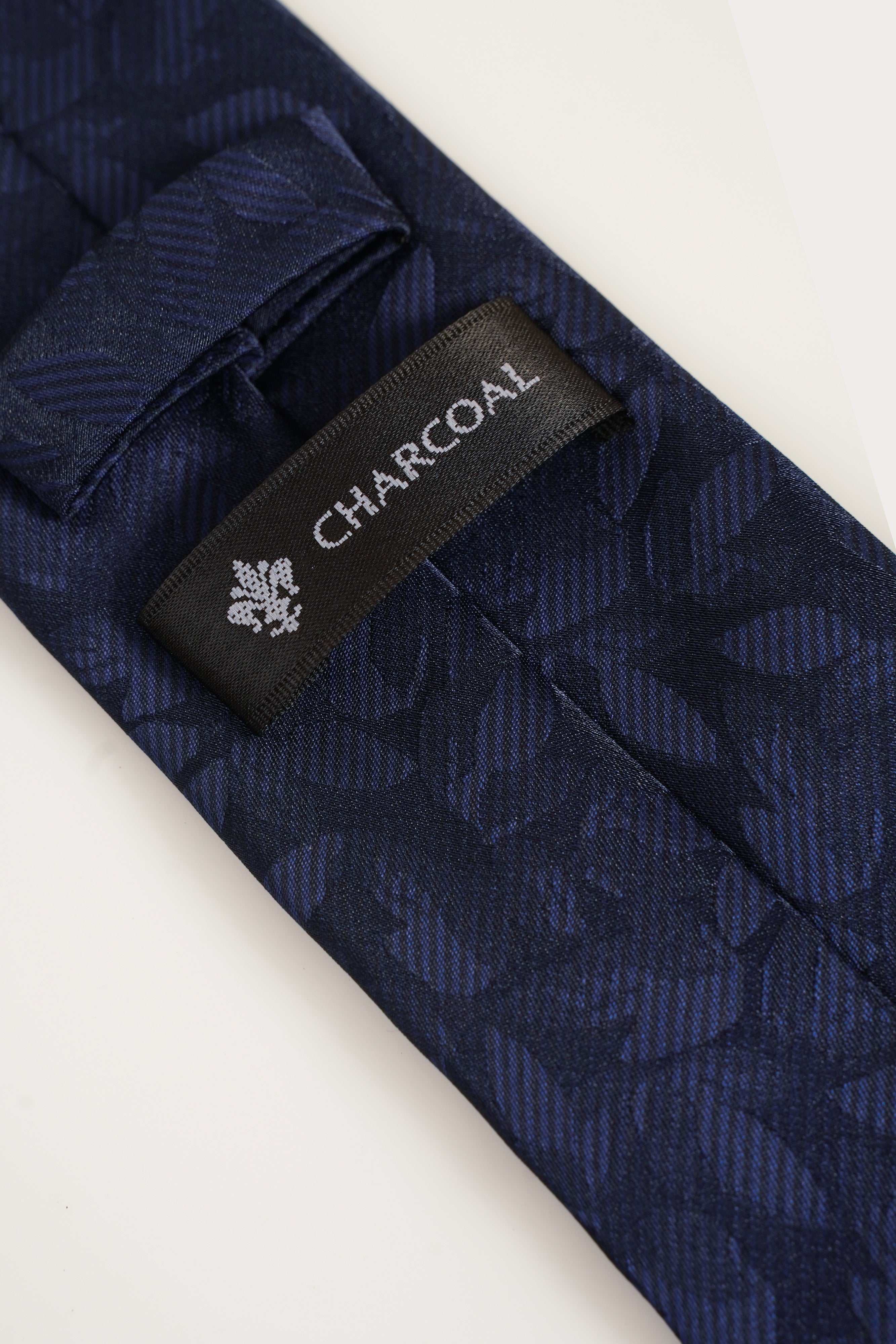 Navy poly silk tie with geometric weave and CHAPCO label near tip