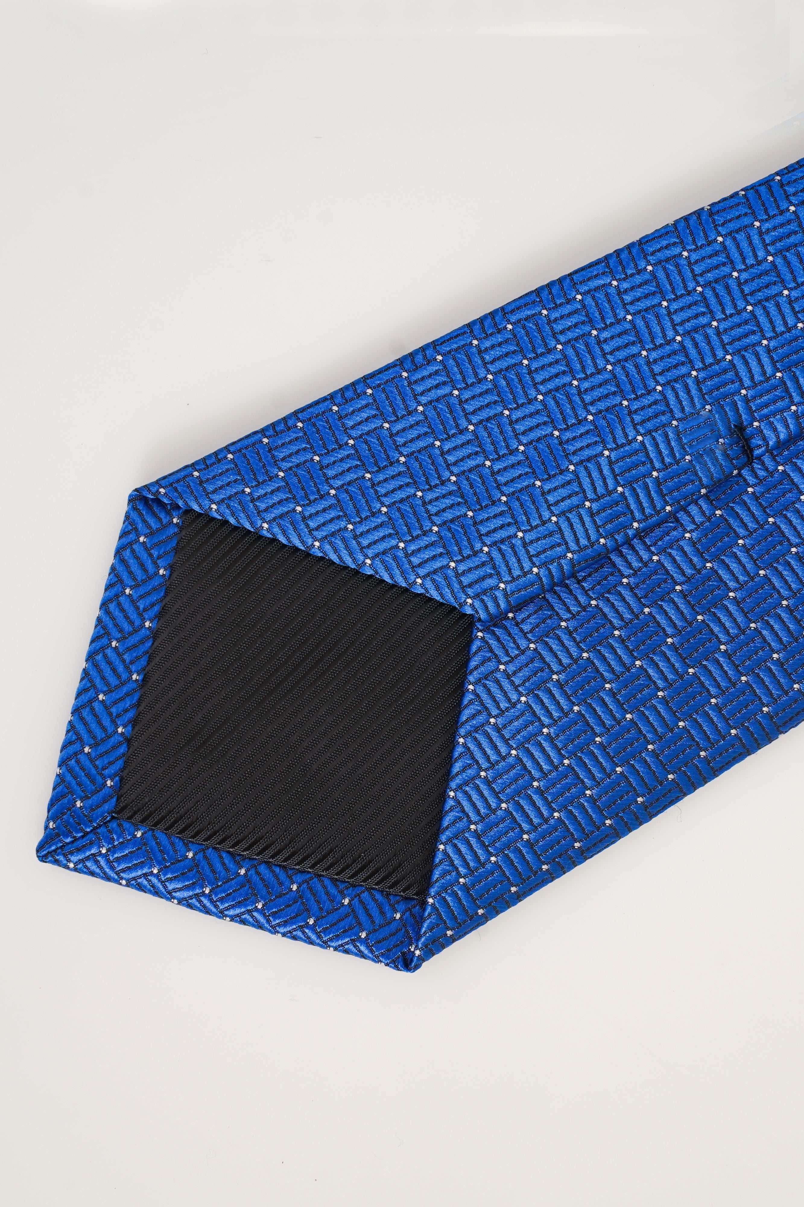 Blue patterned tie close-up of folded tip and woven texture