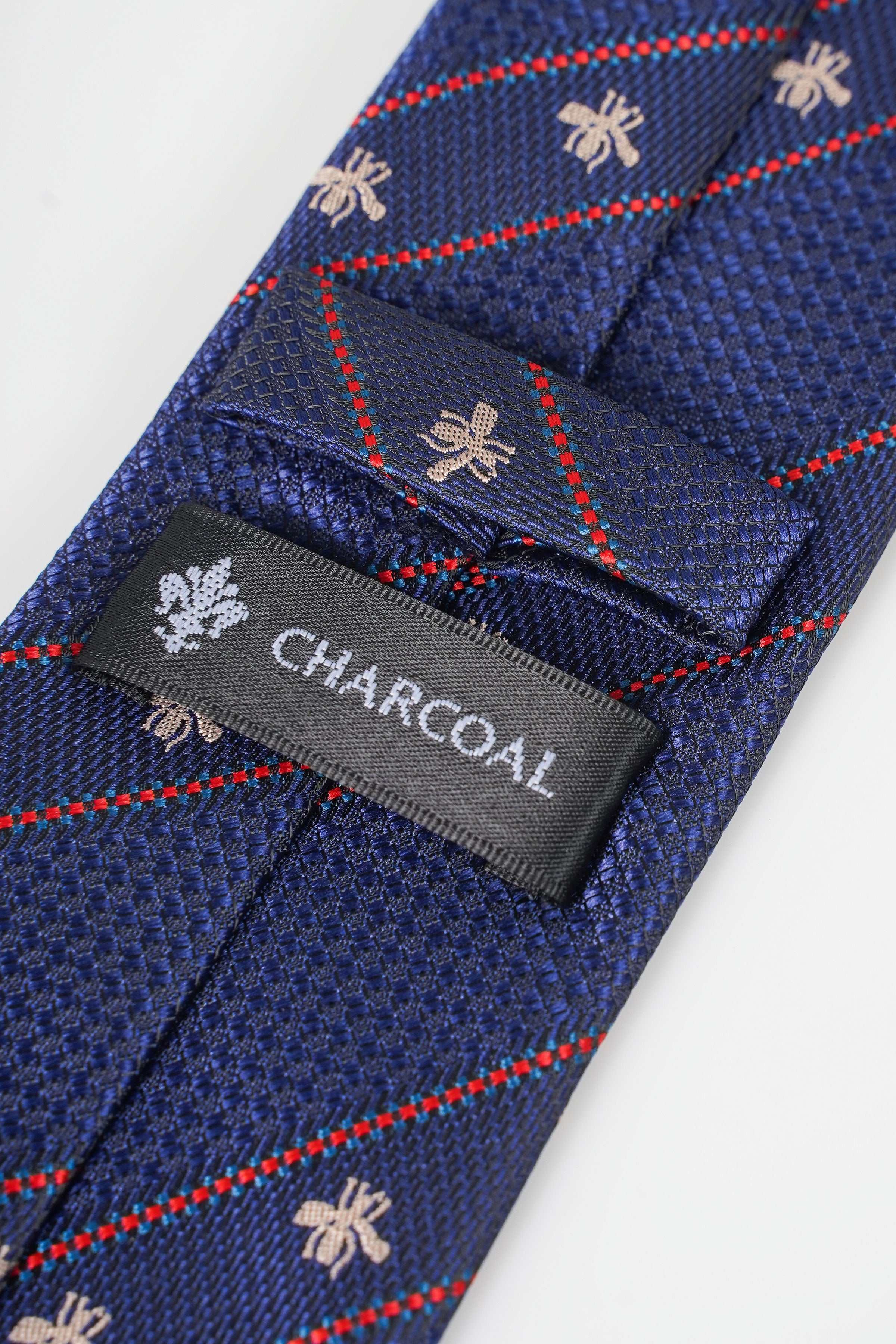 Blue poly silk tie label reading CHARCOAL with red plaid and fleur-de-lis motifs