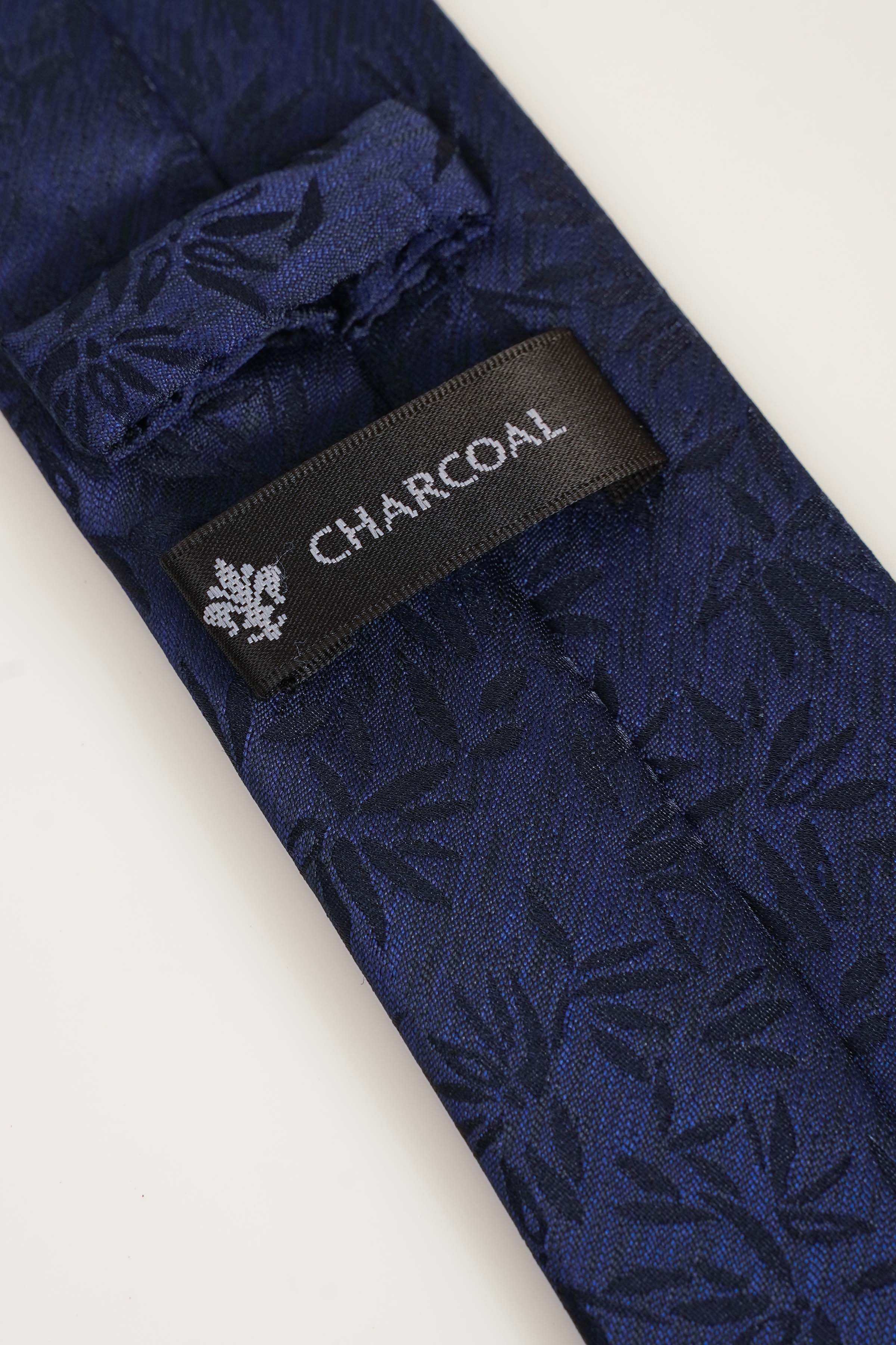 Navy tie close-up with Charcoal fabric label