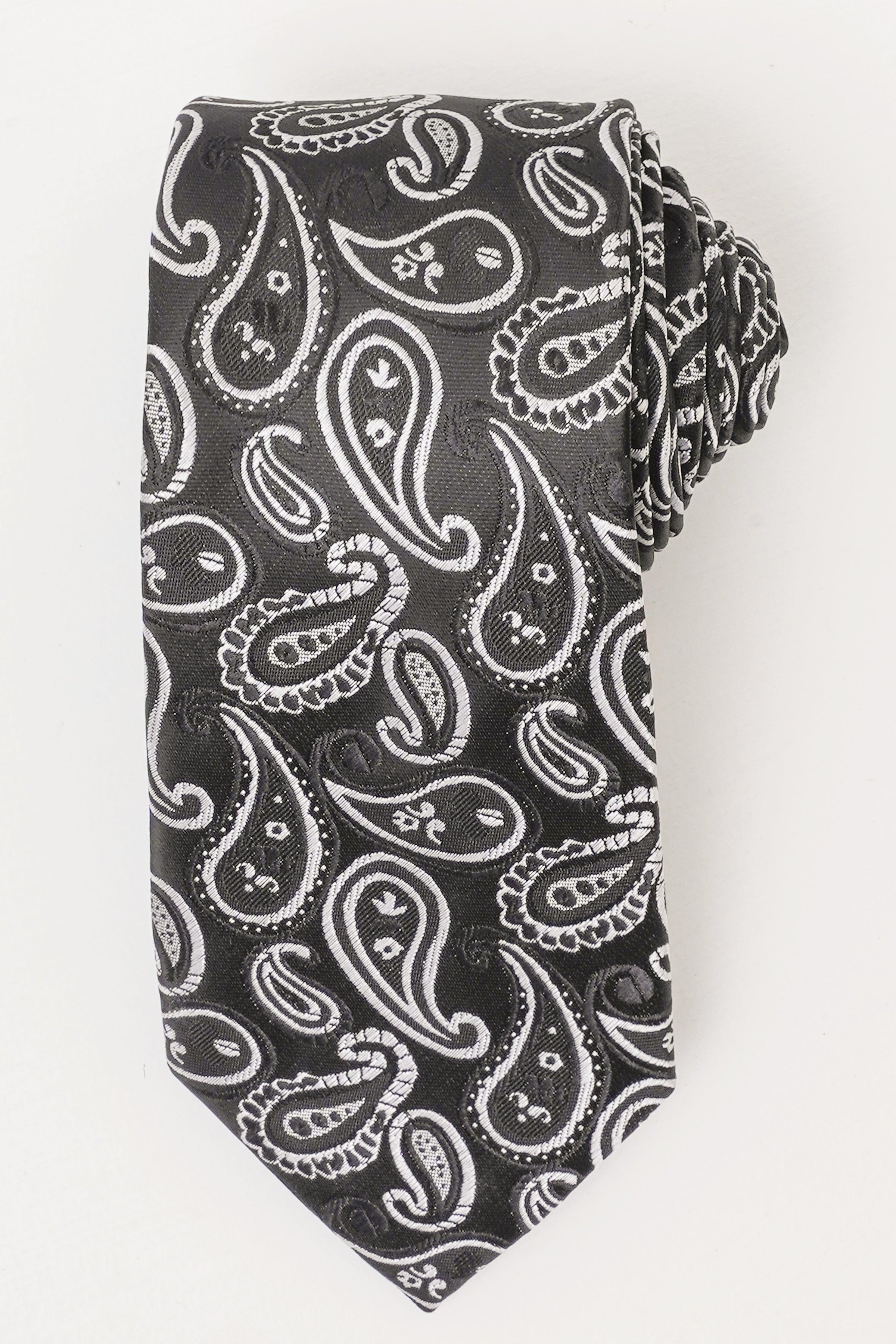 Poly silk tie with dark paisley design and light accents, folded close-up