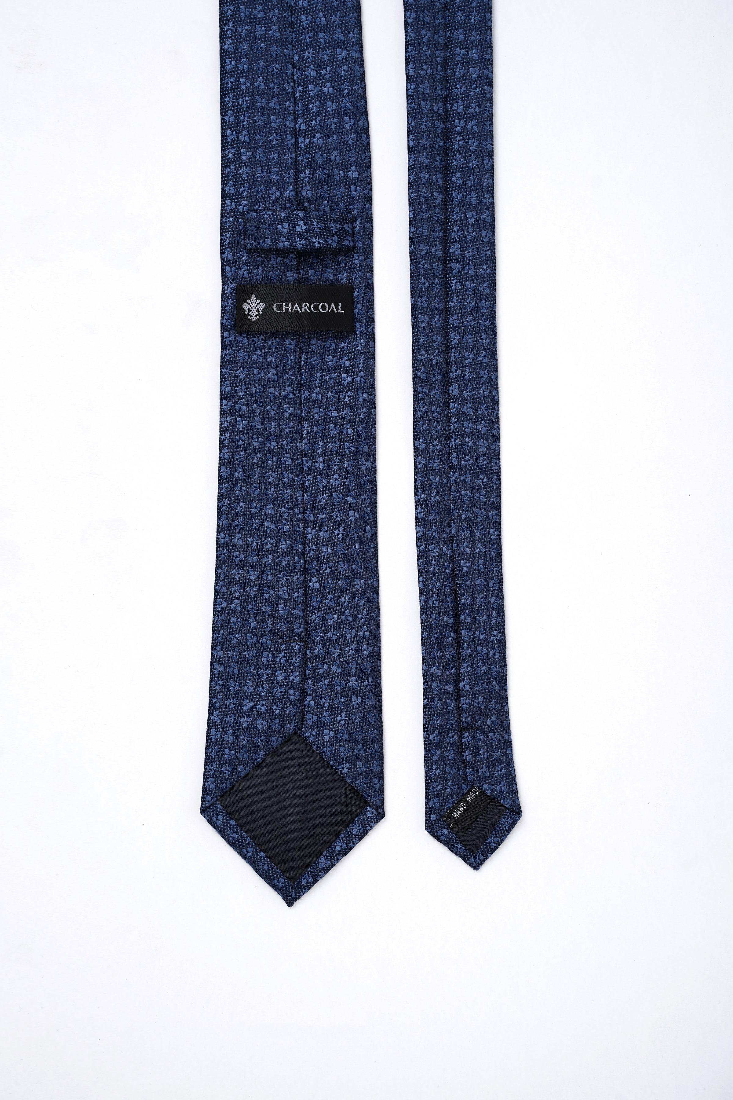 Poly silk tie with dark navy micro-pattern, folded with tag labeled CHARCOAL