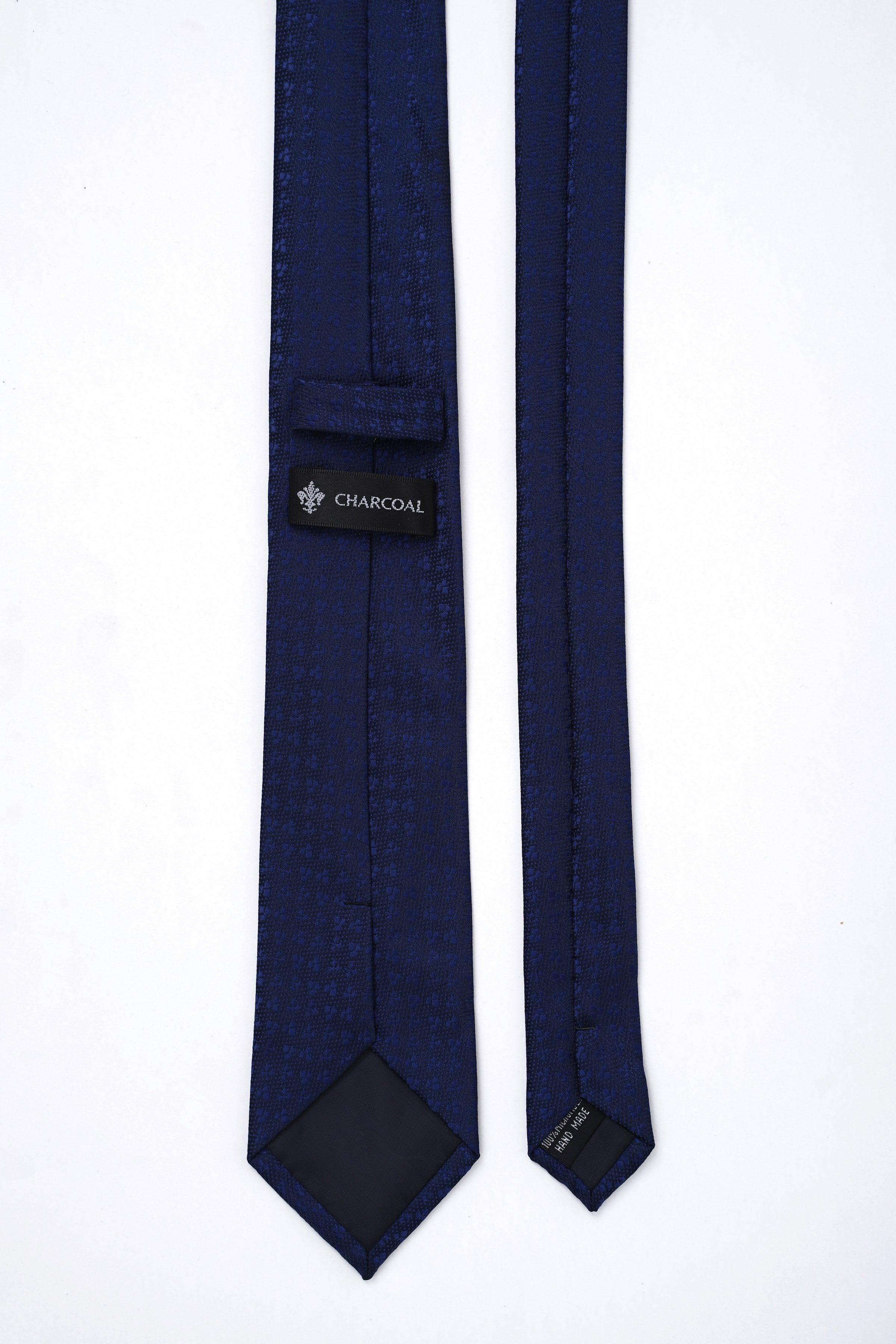 Poly silk tie in dark navy with brand label and keeper strap near tip