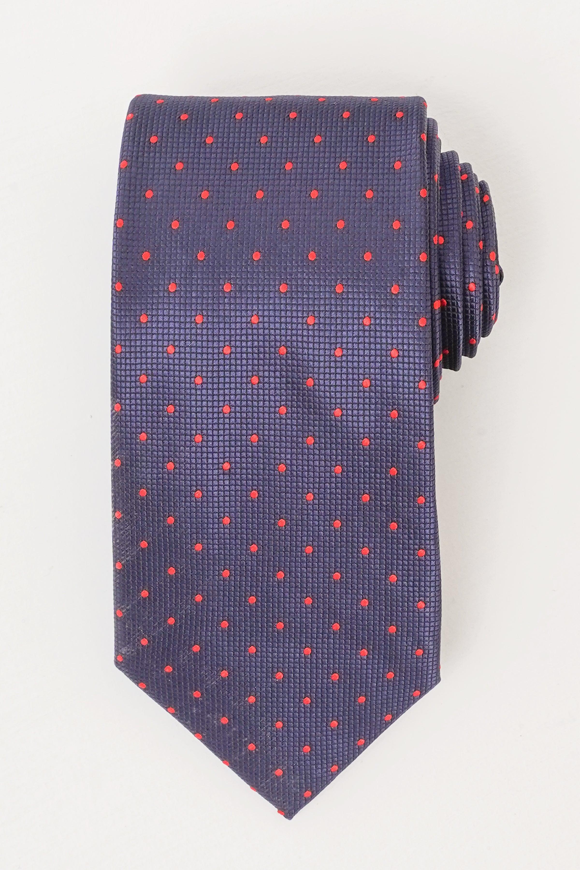 Poly silk tie in dark navy with small red dot pattern, pointed end