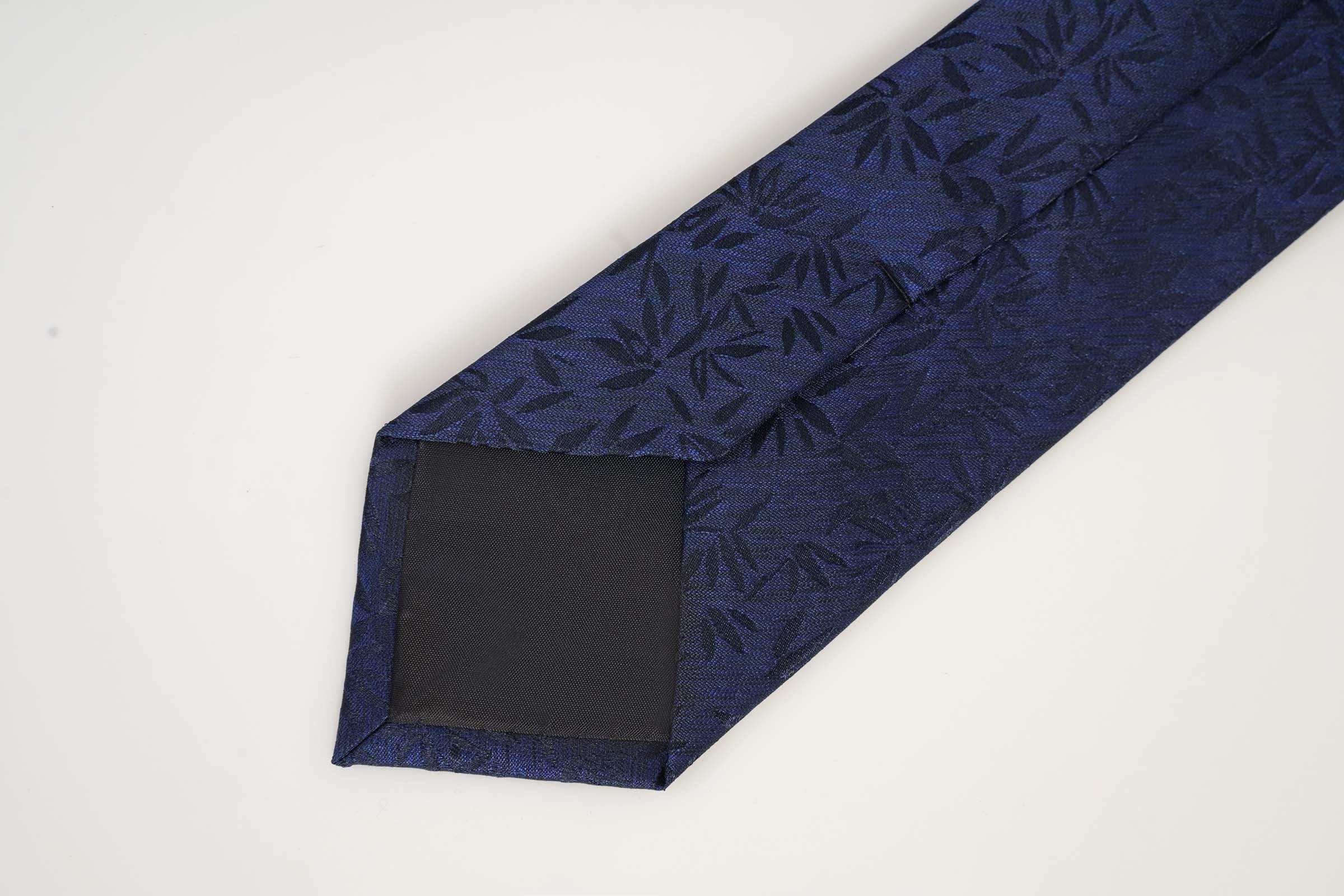 Navy tie with leaf pattern at folded end