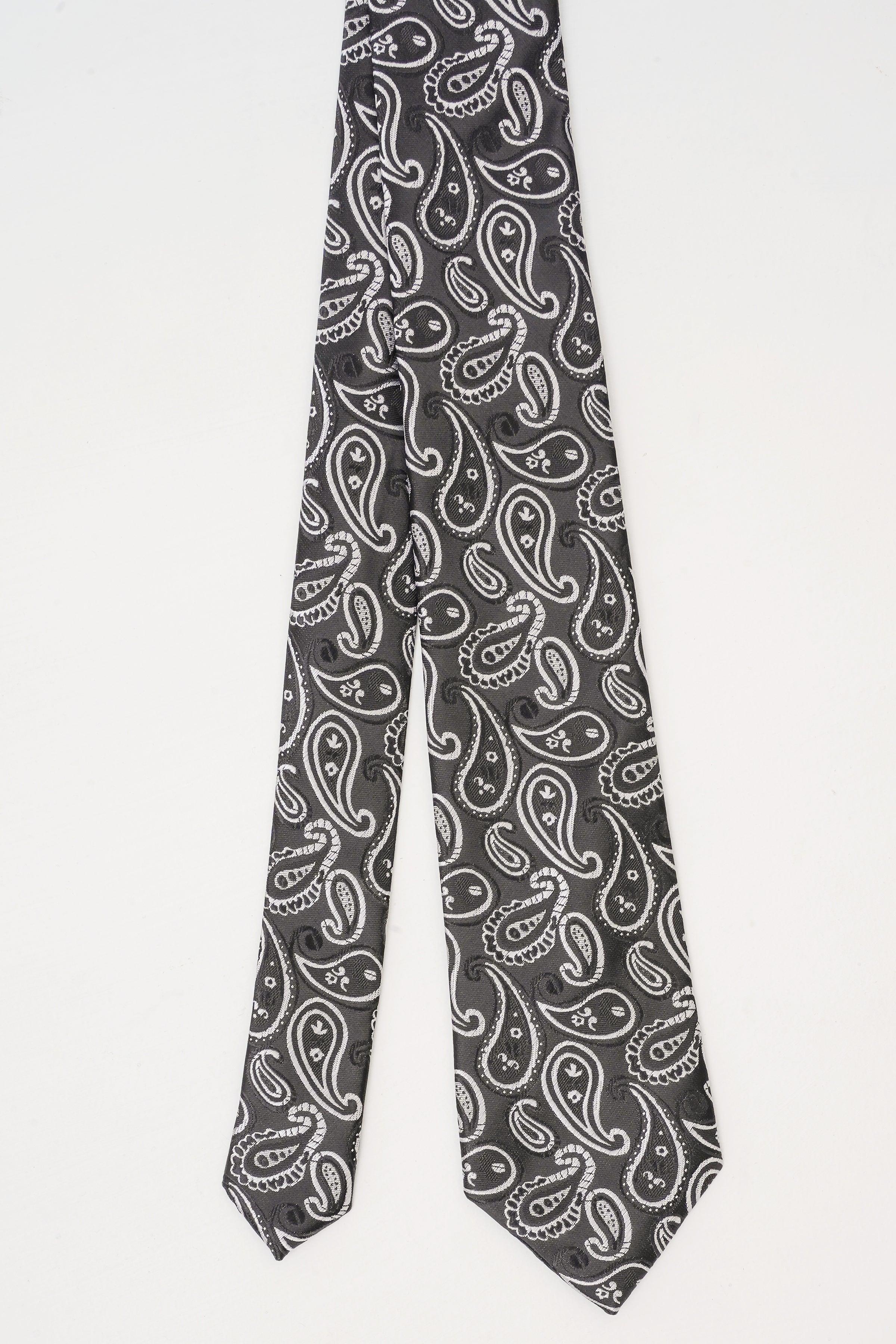 Poly silk tie in dark paisley print with light swirl patterns, narrow end view