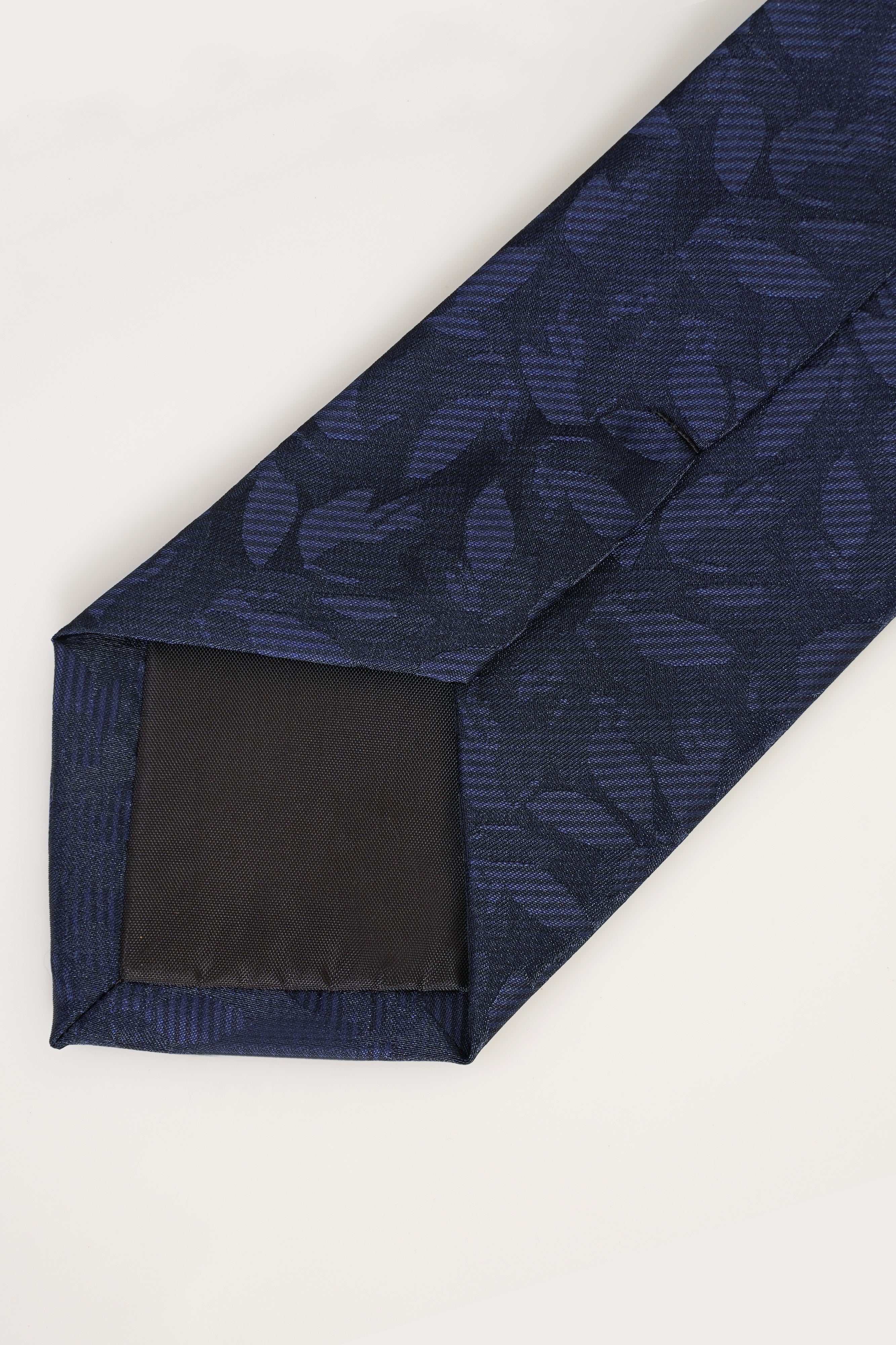 Dark navy poly silk tie close-up of pointed tip and stitched edge