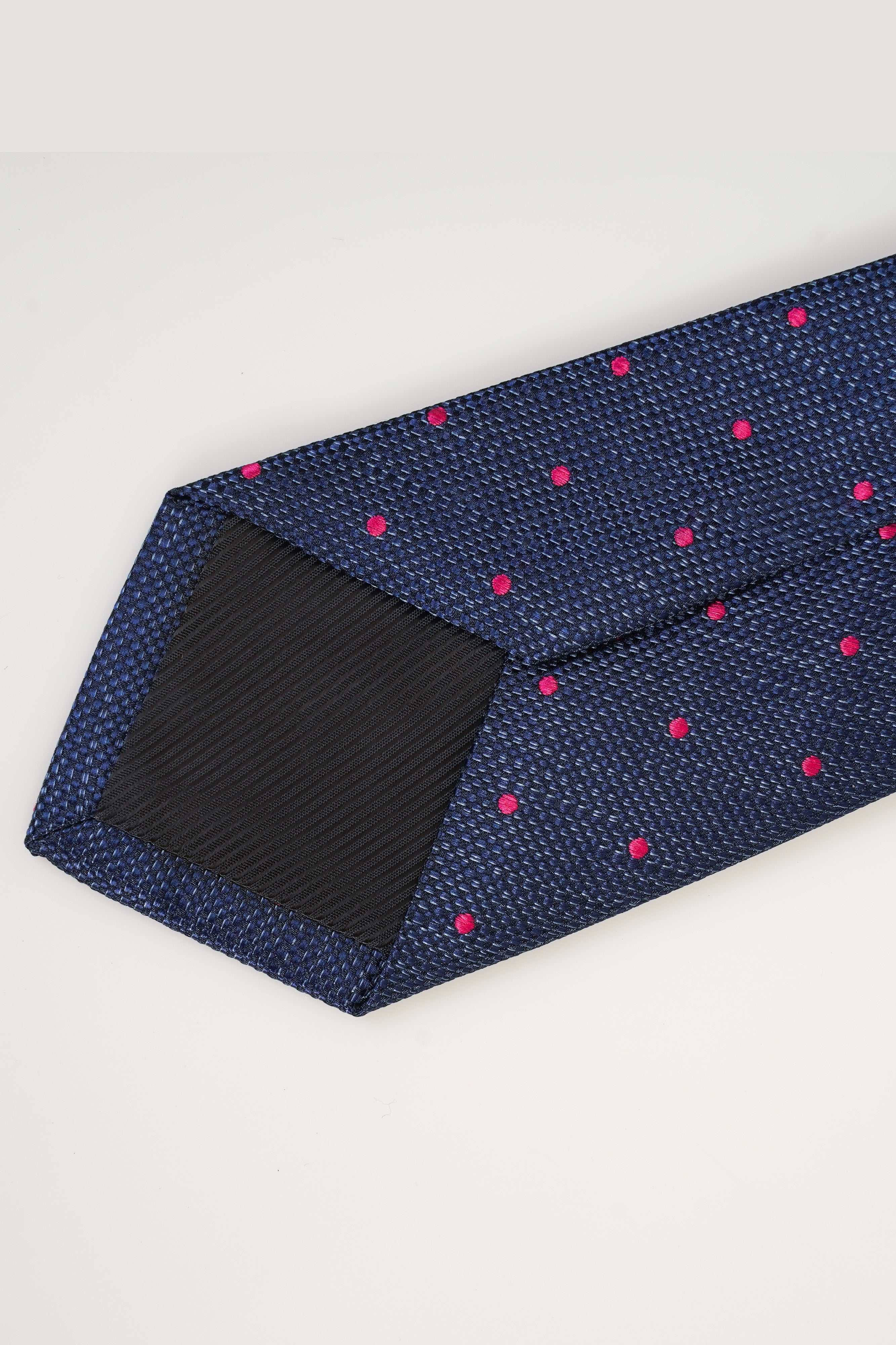 Poly silk tie in dark navy with small pink dot pattern