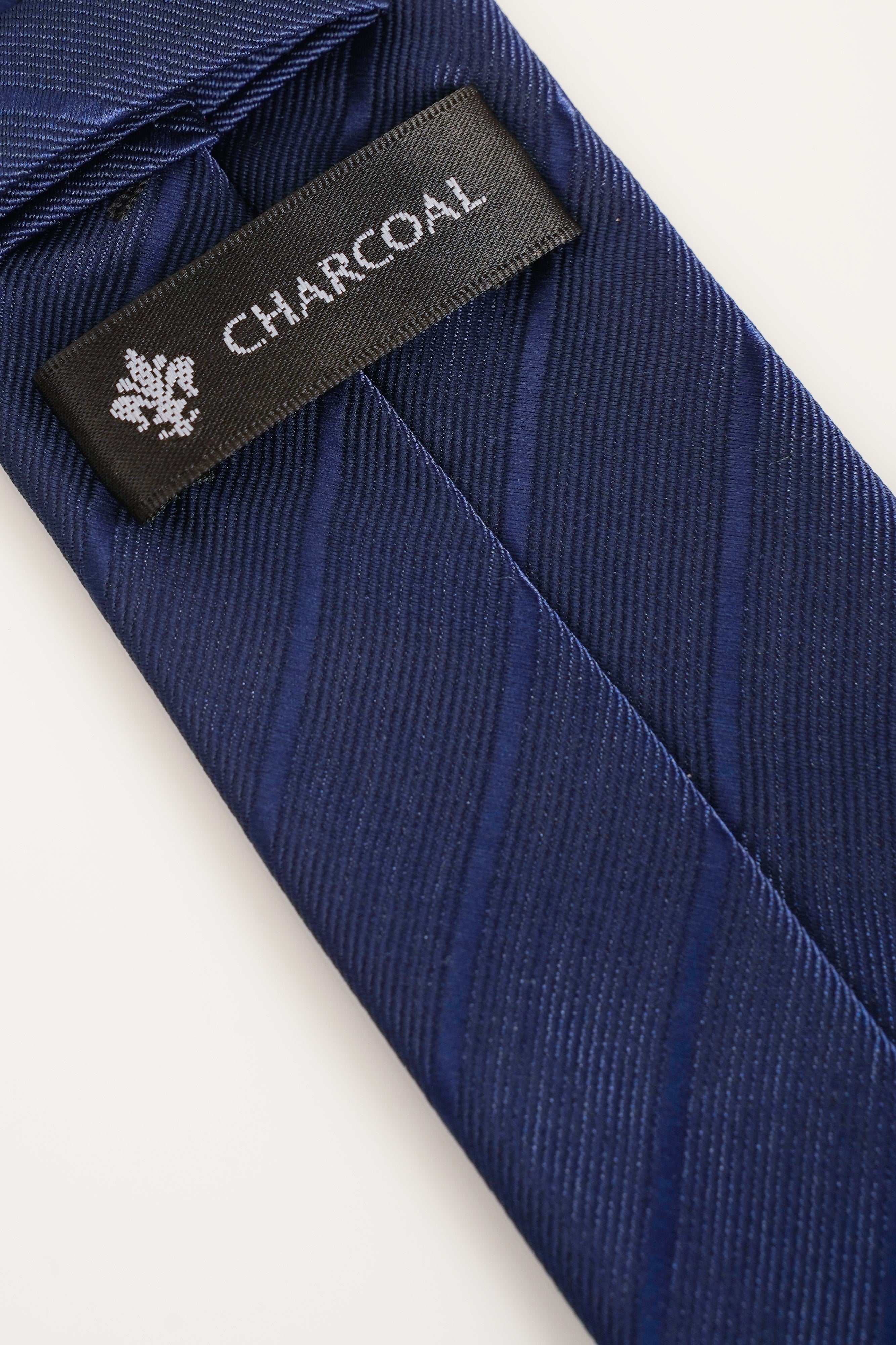 Poly-silk tie with CHARCOAL label and diagonal stripes in dark blue