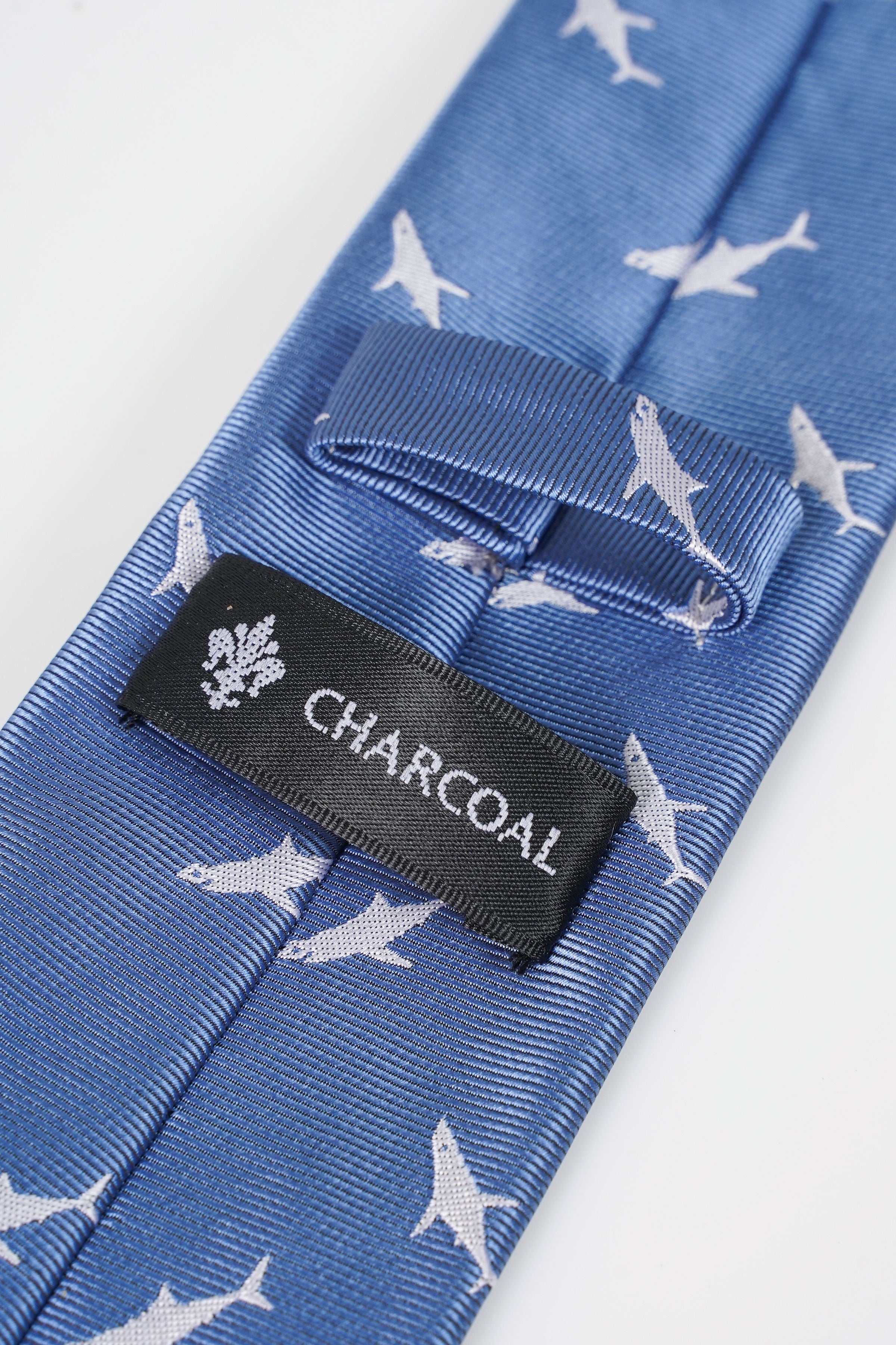 Blue necktie with white bird motif and CHACOLAIL fabric label