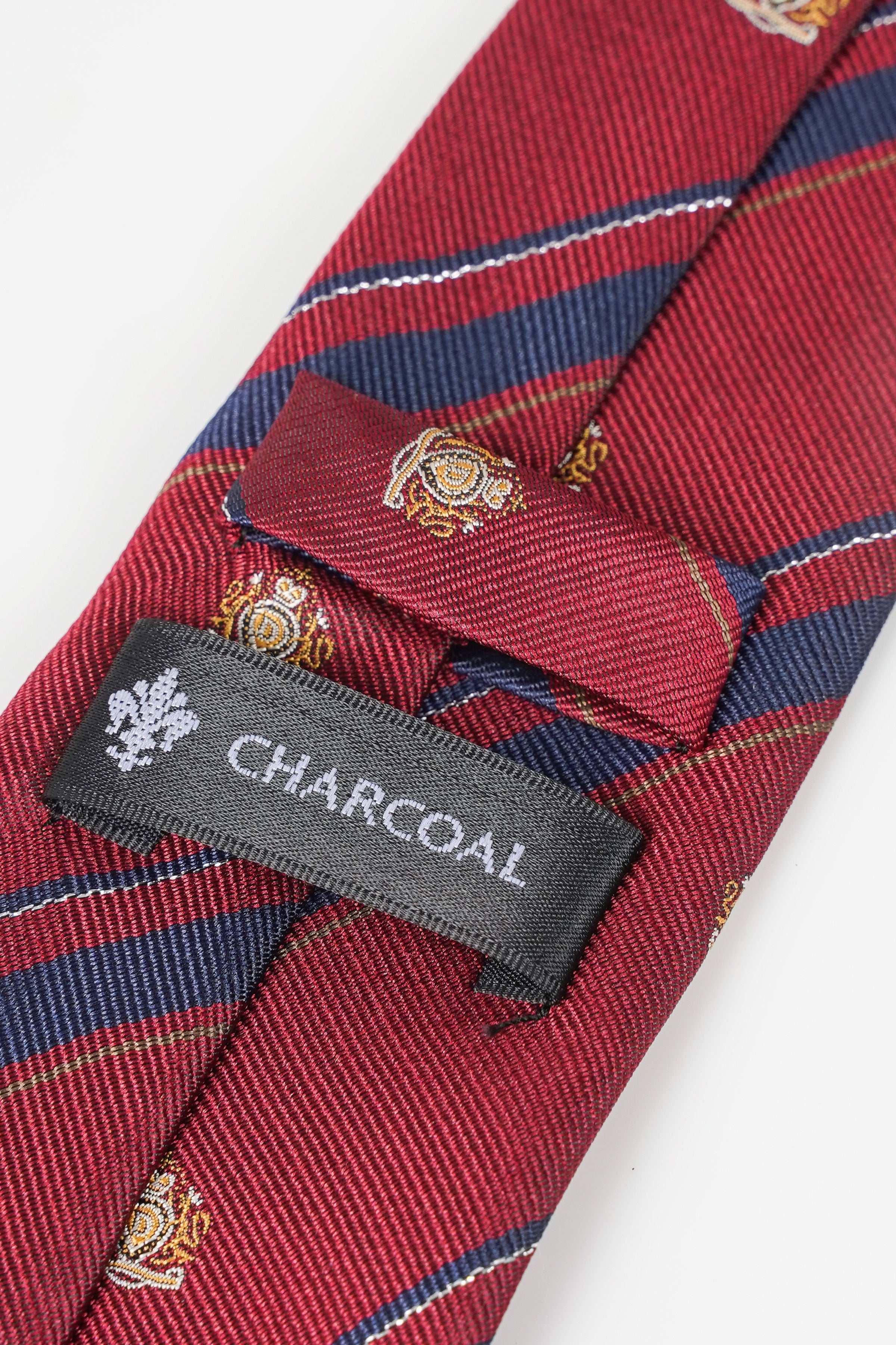 Red necktie with navy stripes, gold crest motifs, Charcoal label near tip