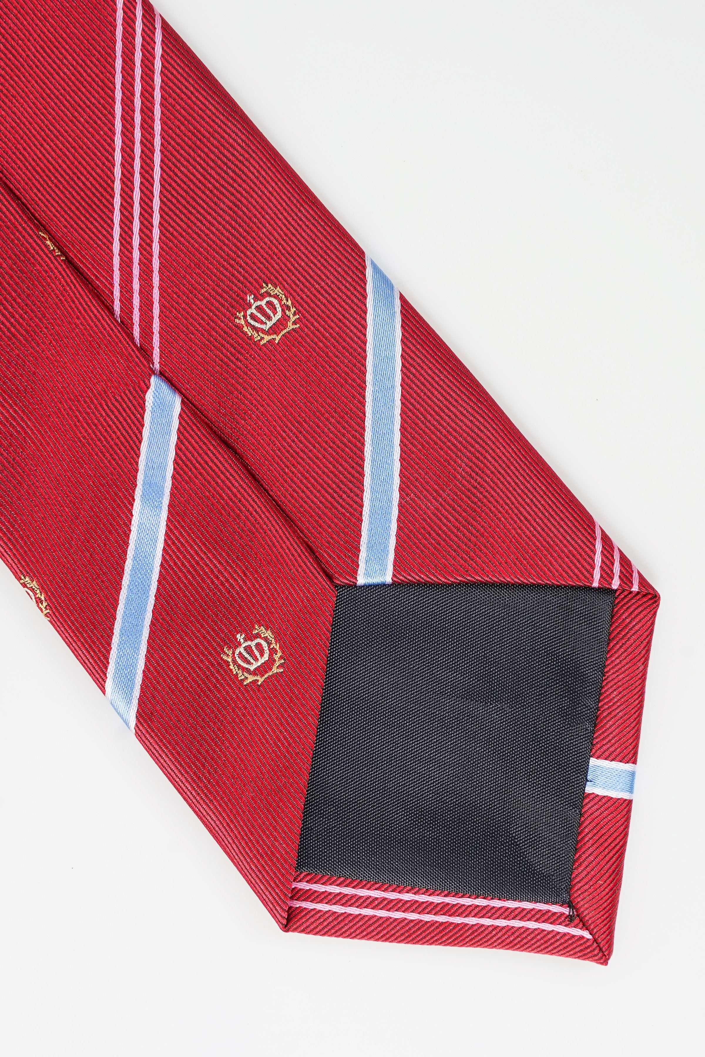 Red tie with light blue diagonal stripes; folded tip with crest accents