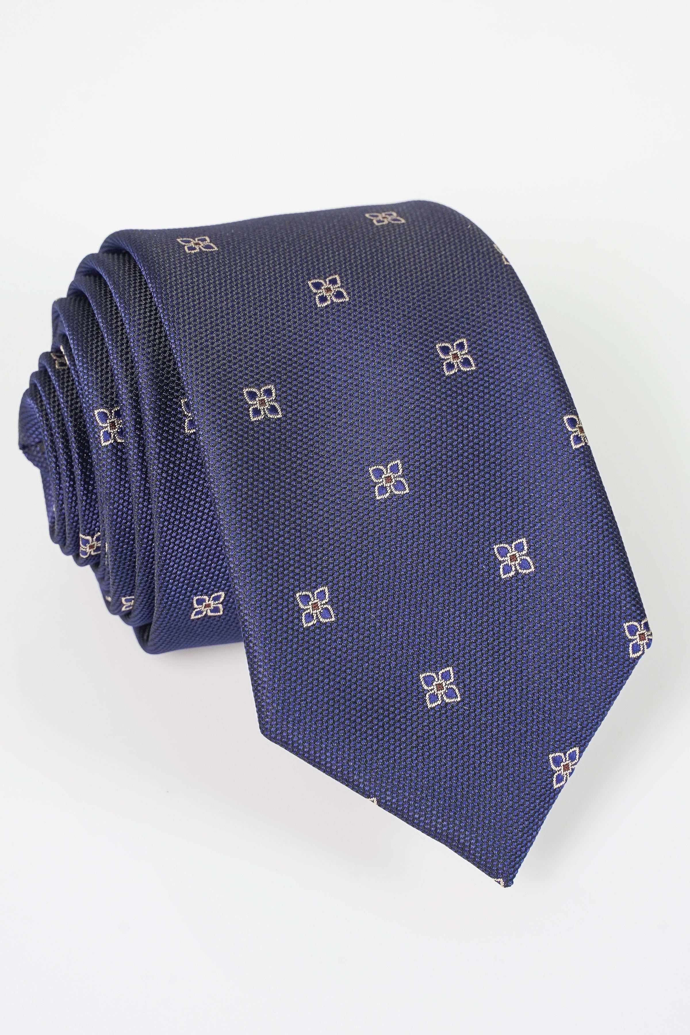 Dark blue poly silk necktie folded, repeating gold geometric motifs