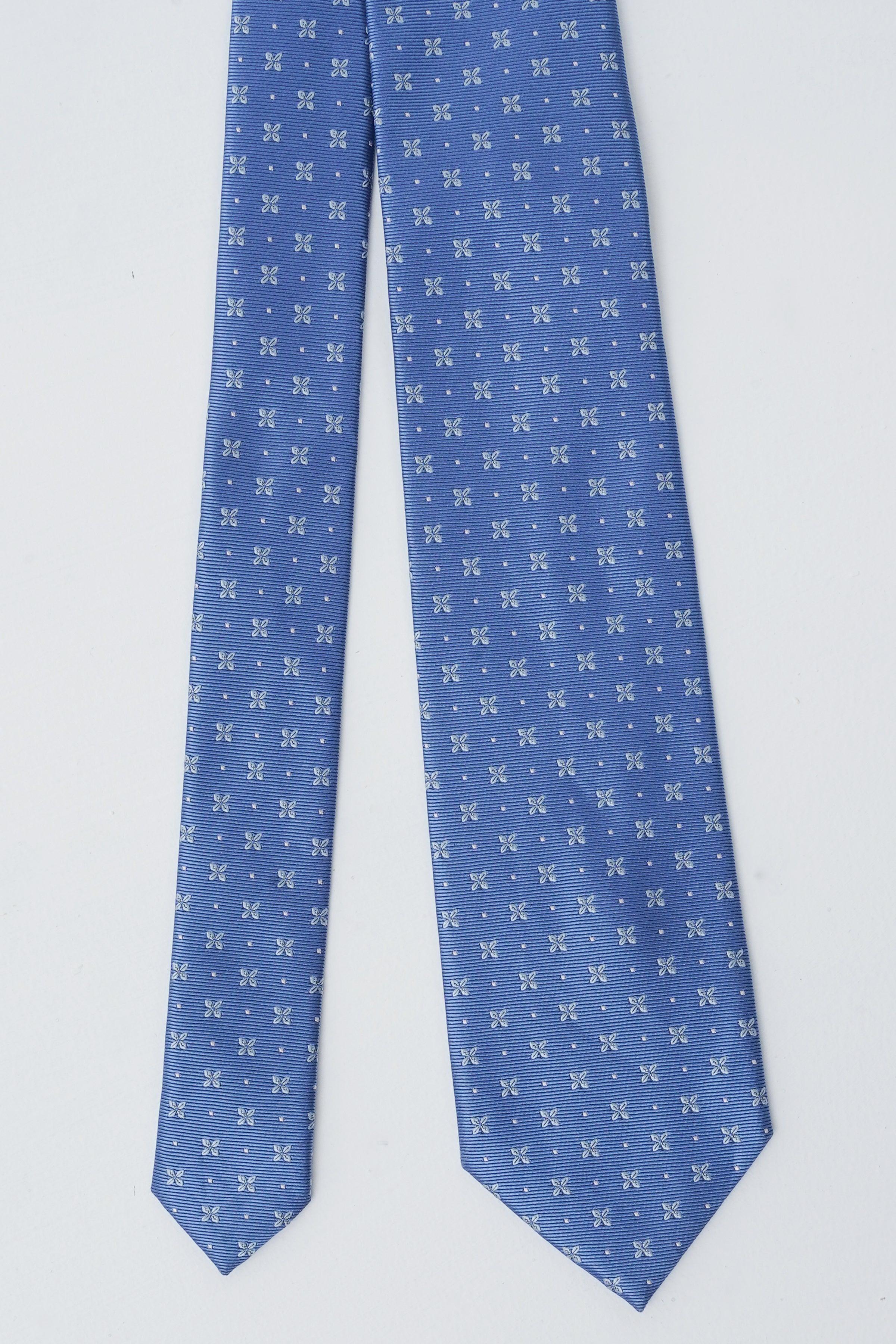 Blue patterned necktie with tiny white bows, long narrow silhouette