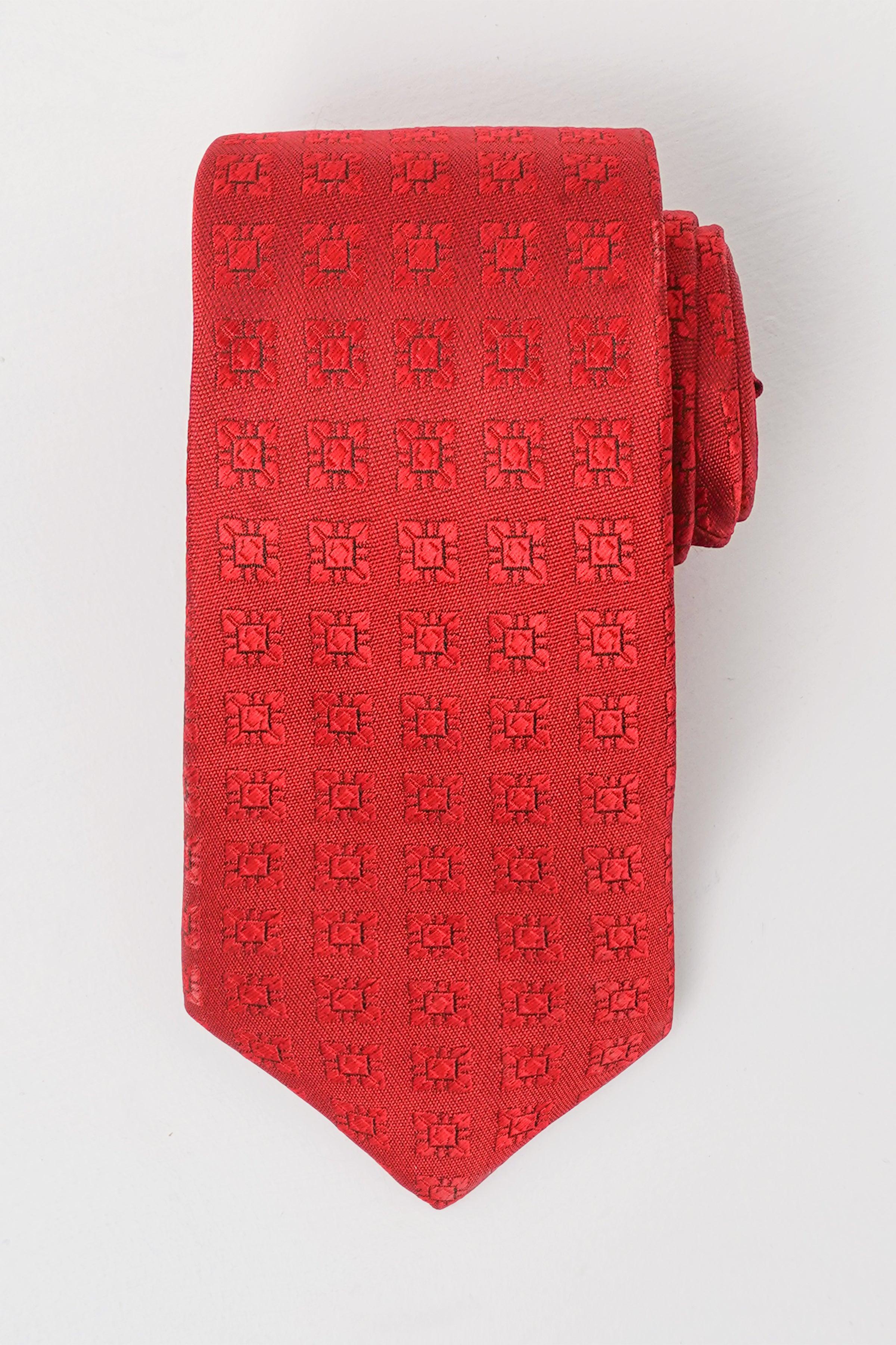 Red patterned polyester silk tie with repeating monogram texture