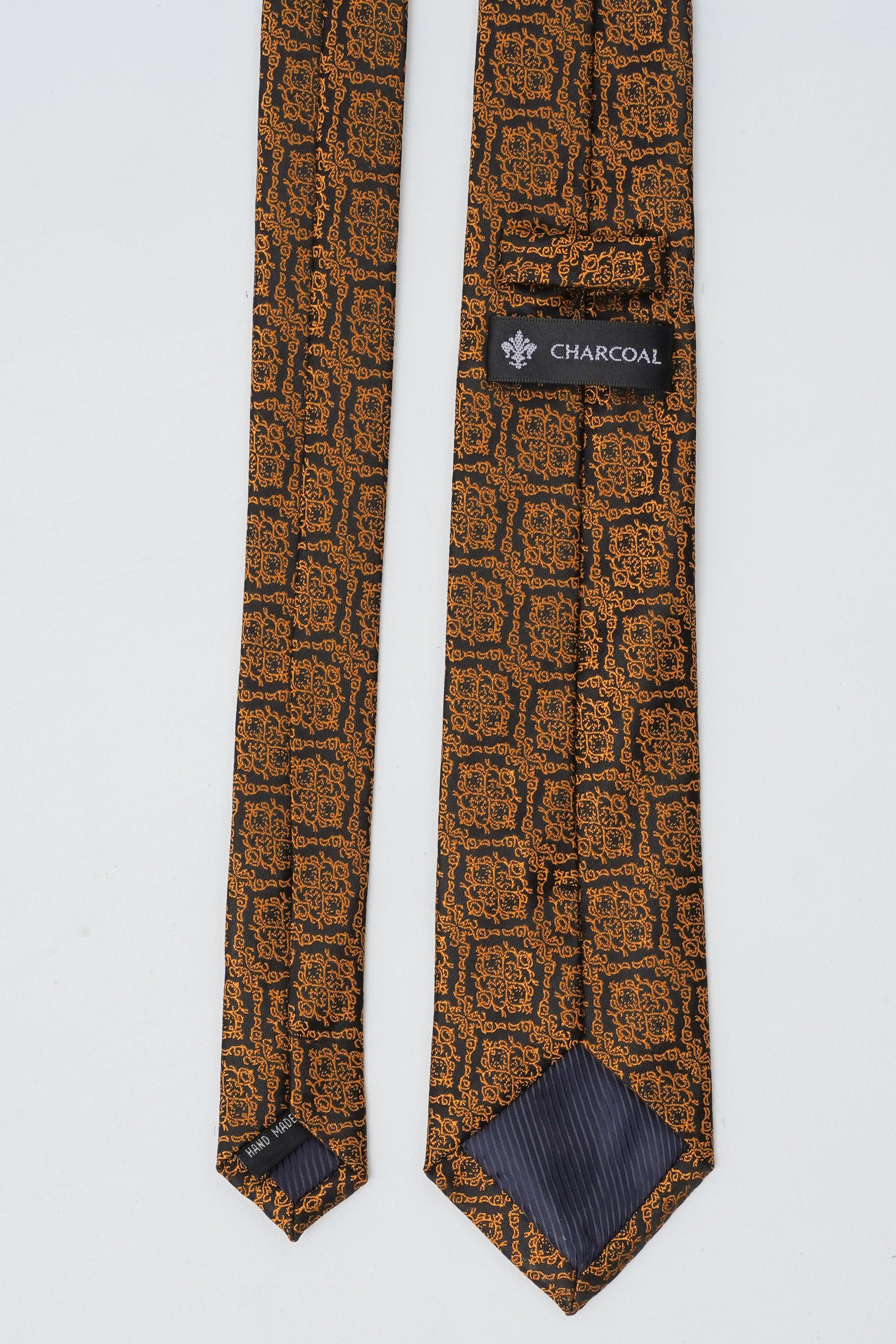 Poly silk tie with repeating geometric motif, dark brown base and navy accents