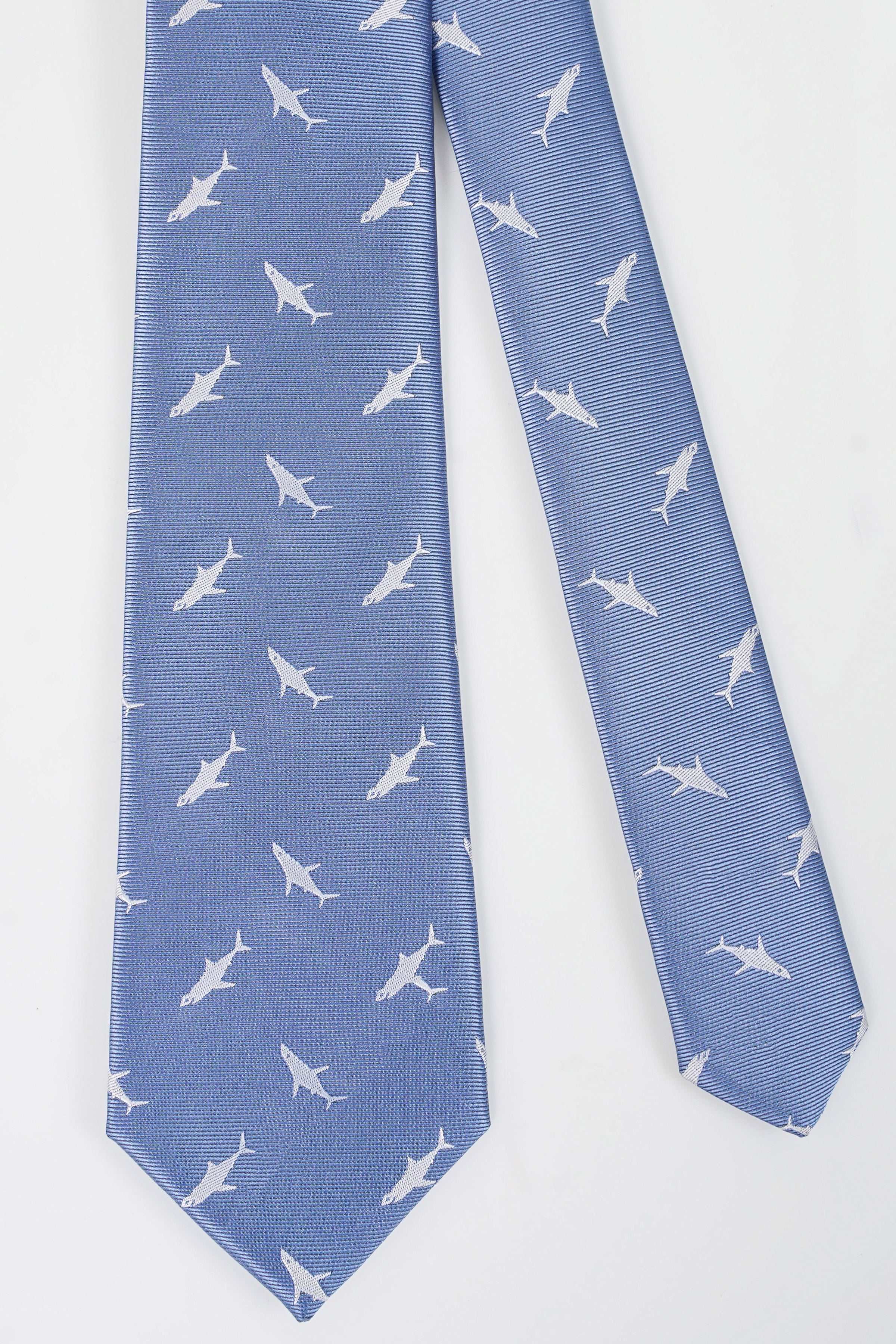 Blue necktie with repeating white bird pattern, angled view