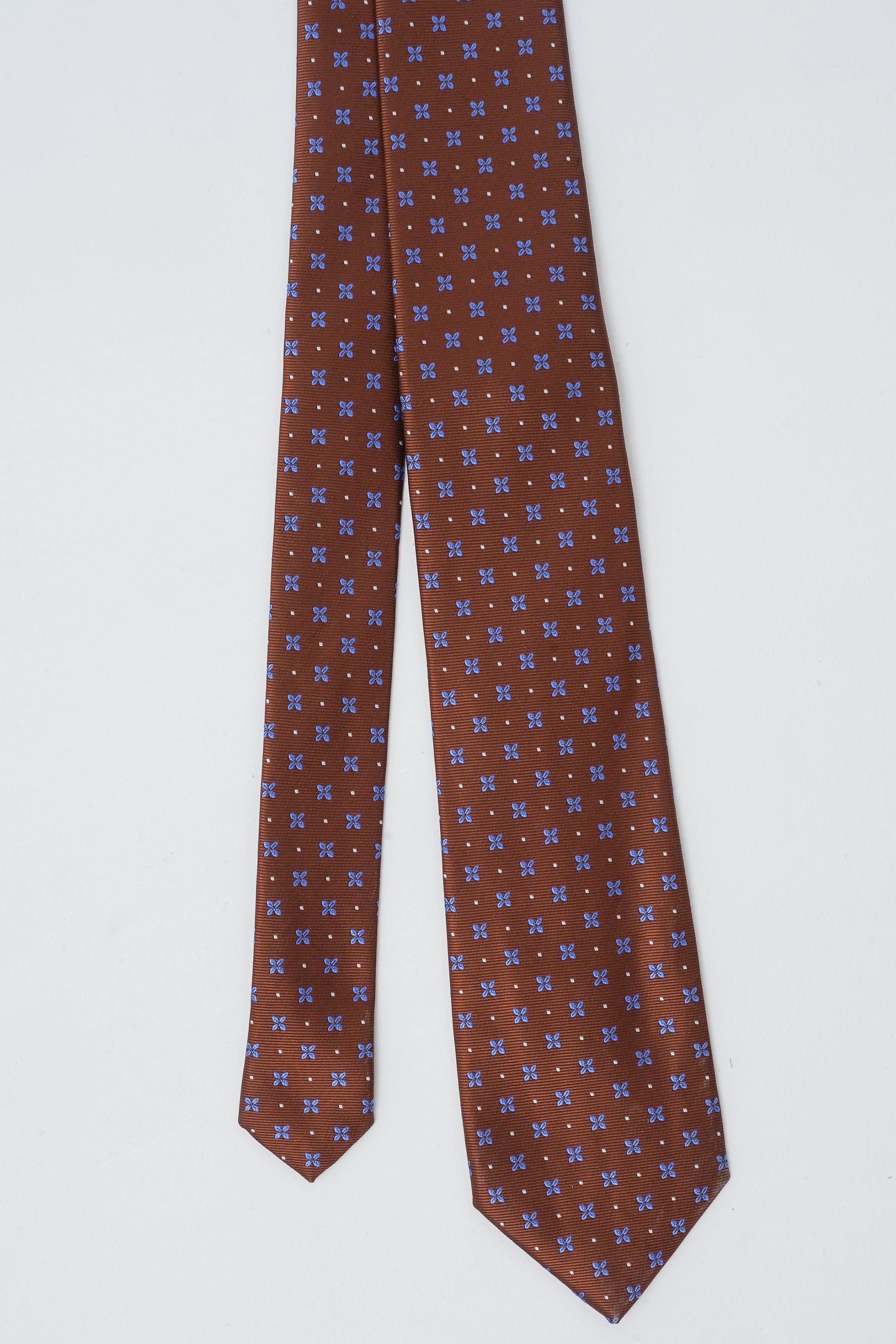 Brown patterned necktie with dense small blue and light motifs.