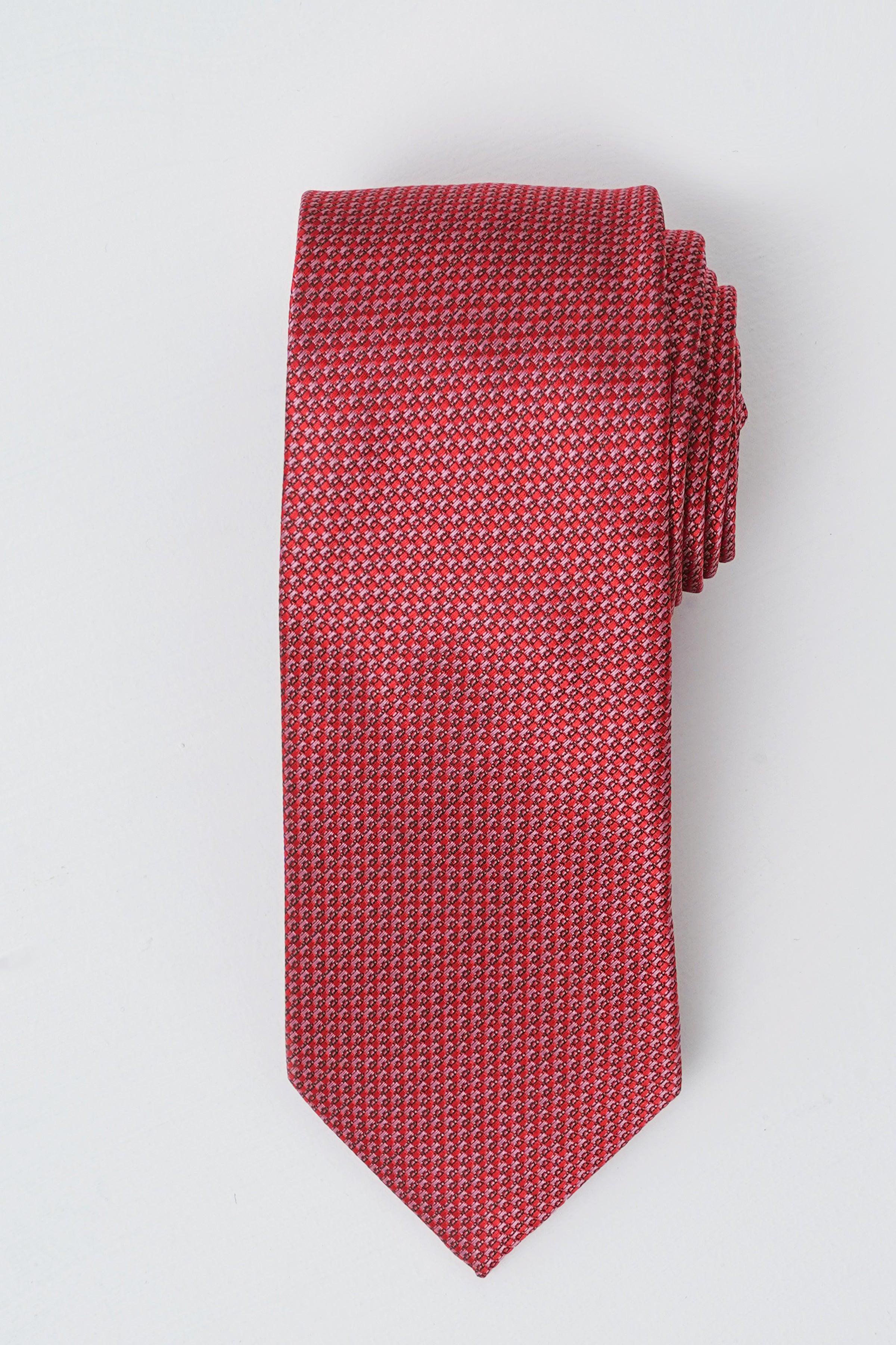 Red patterned poly silk tie with narrow width and pointed end.