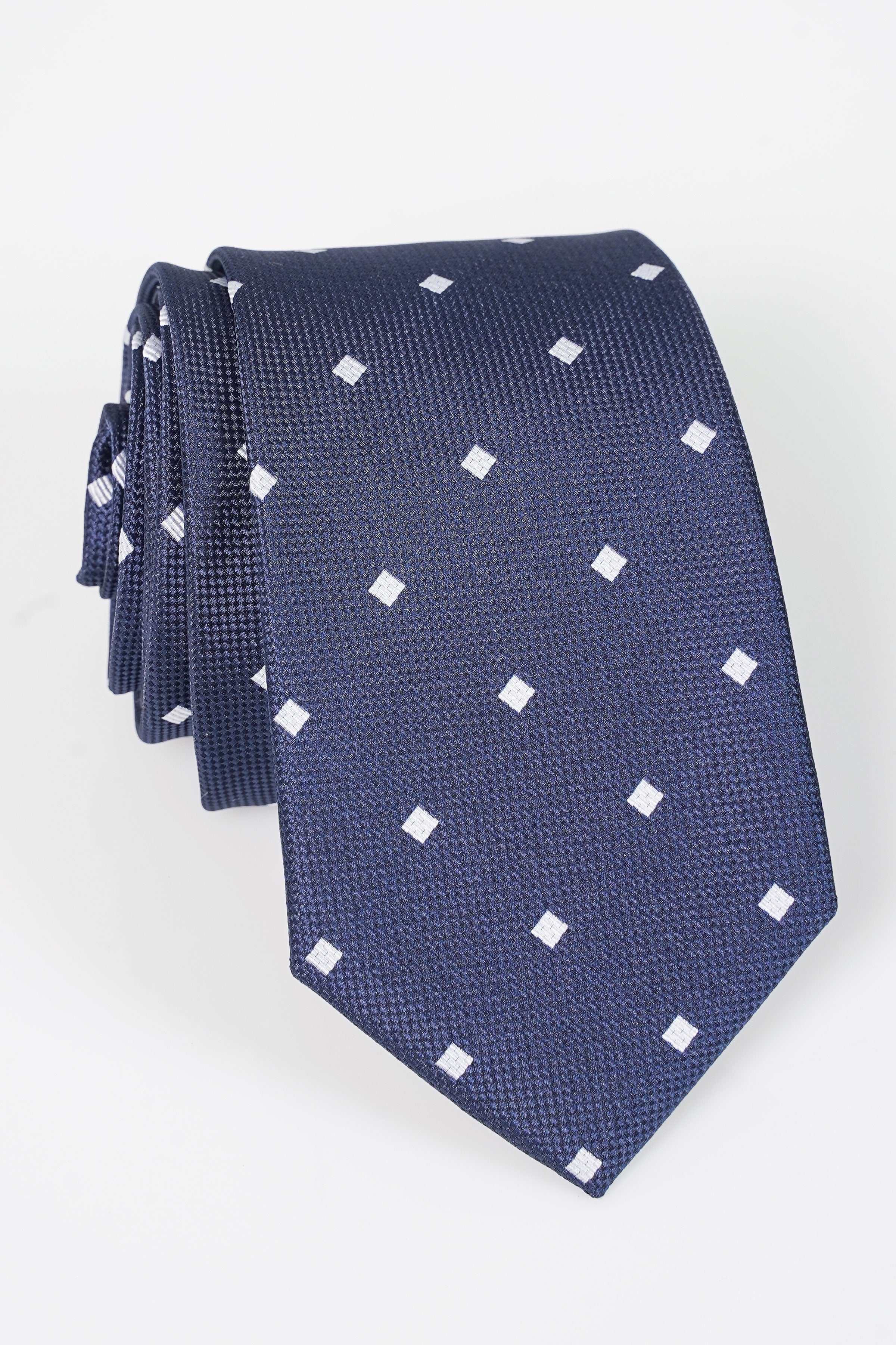 Dark blue polyster tie with small white square pattern, folded end and tip visible