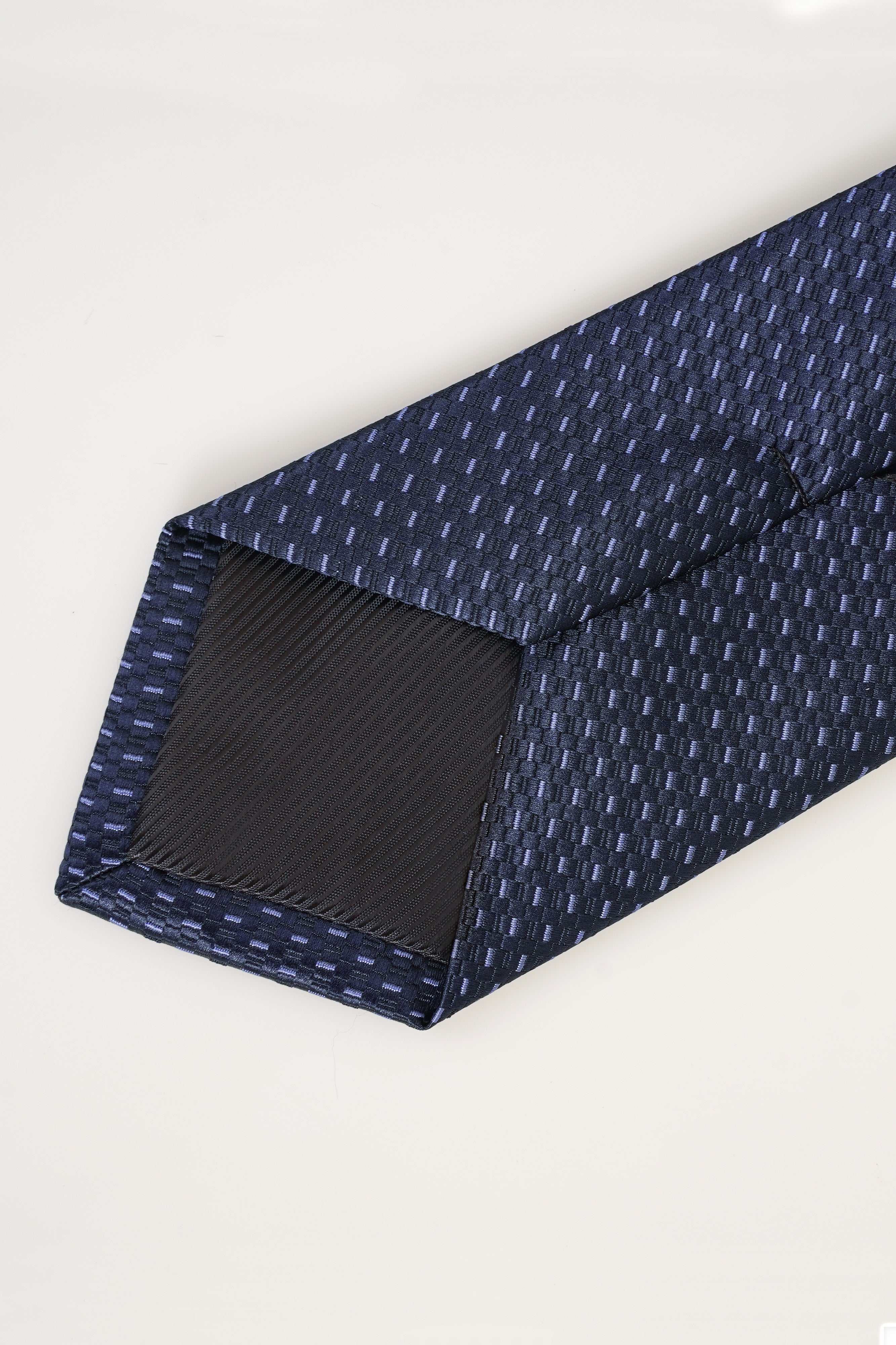 Navy patterned tie end with stitched edge and textured woven weave