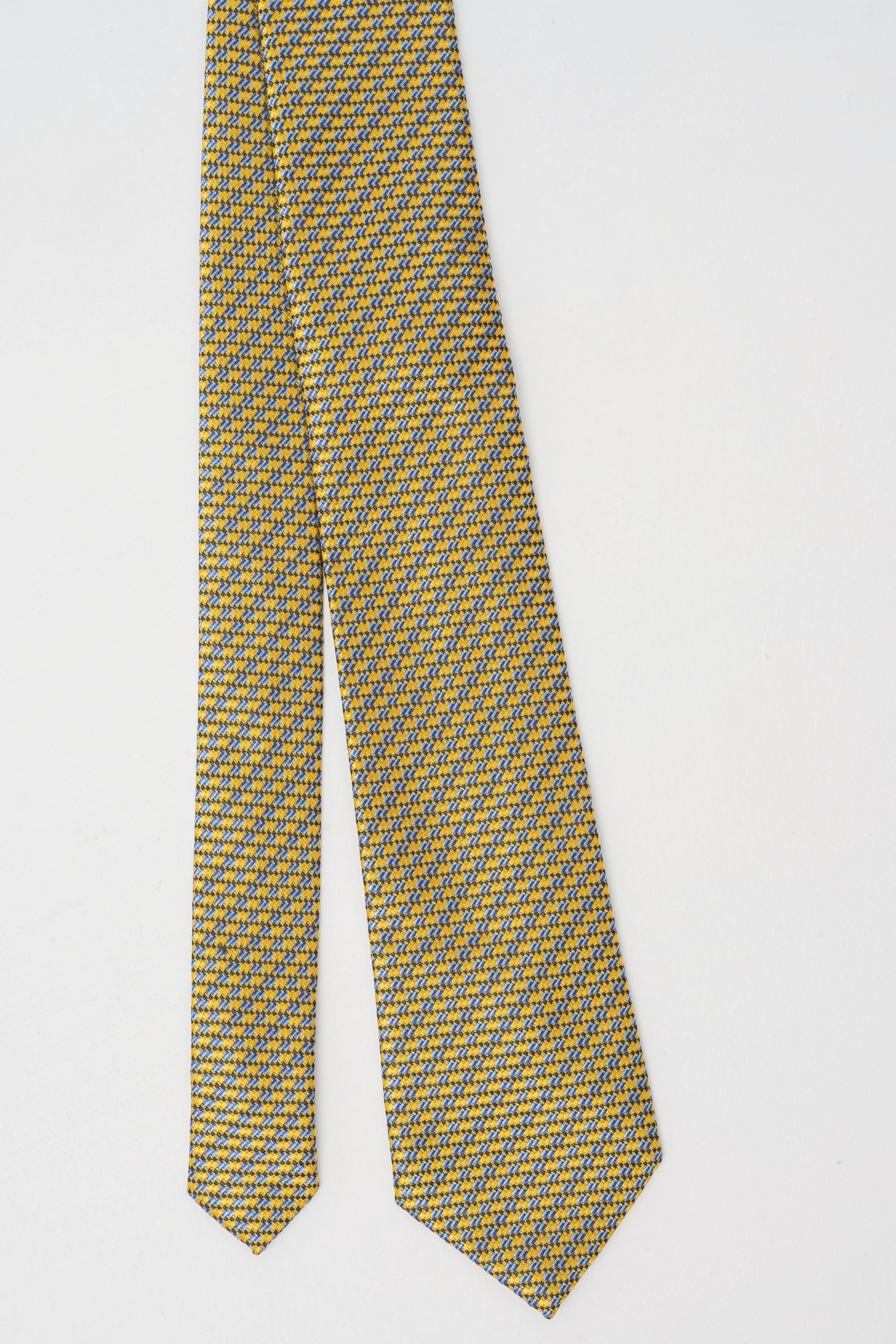 Patterned necktie, long slim fall with pointed ends; yellow with dark blue texture.