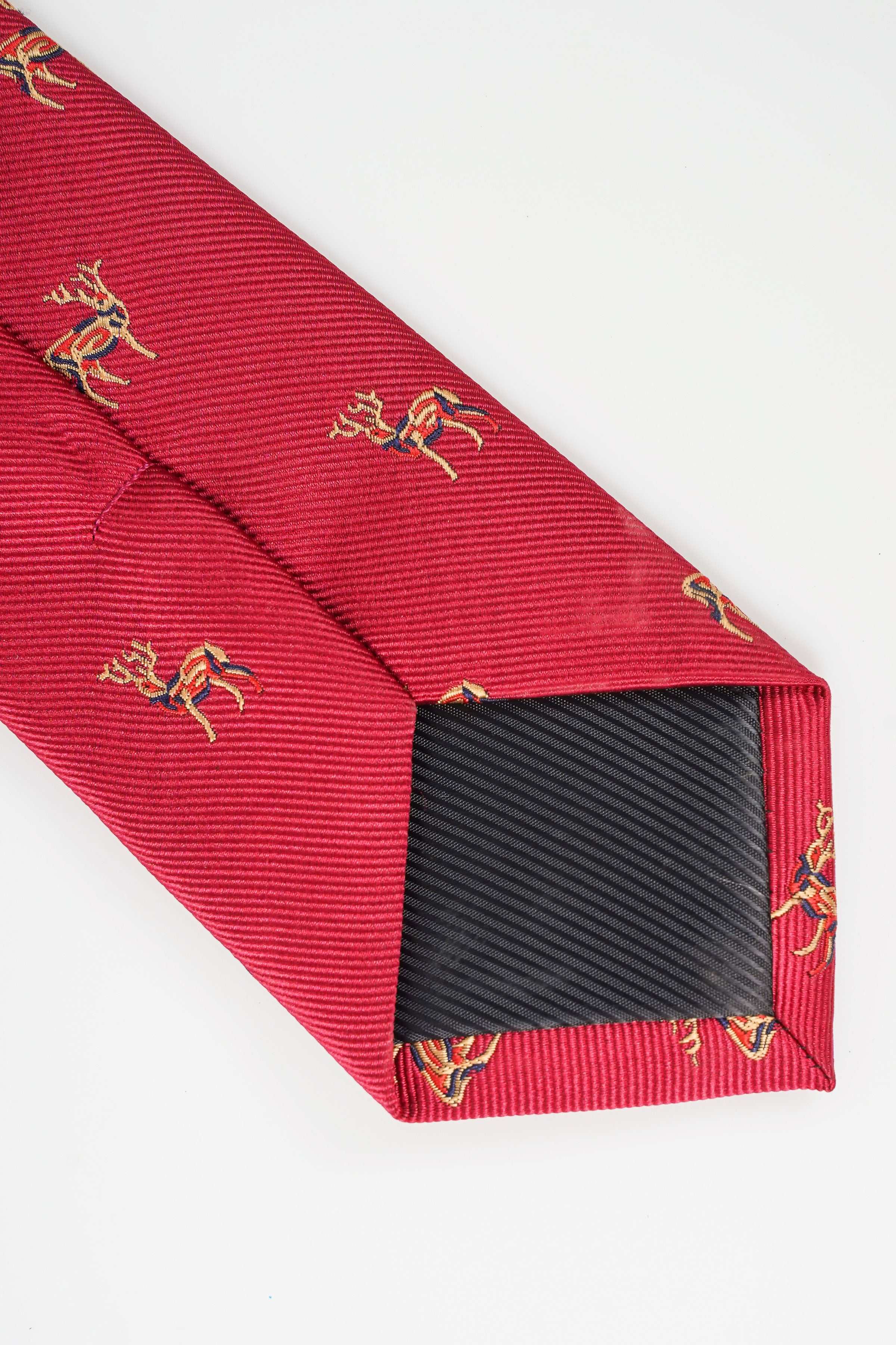 Red poly silk tie with gold animal pattern and charcoal striped underside
