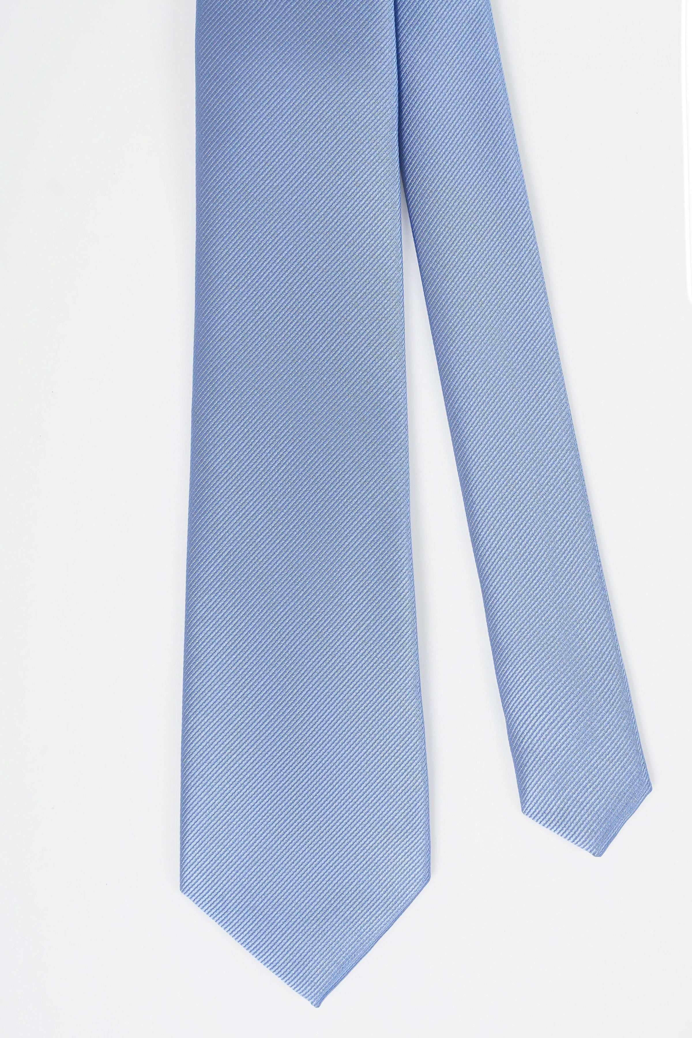 Light blue poly silk tie hanging straight with narrow end