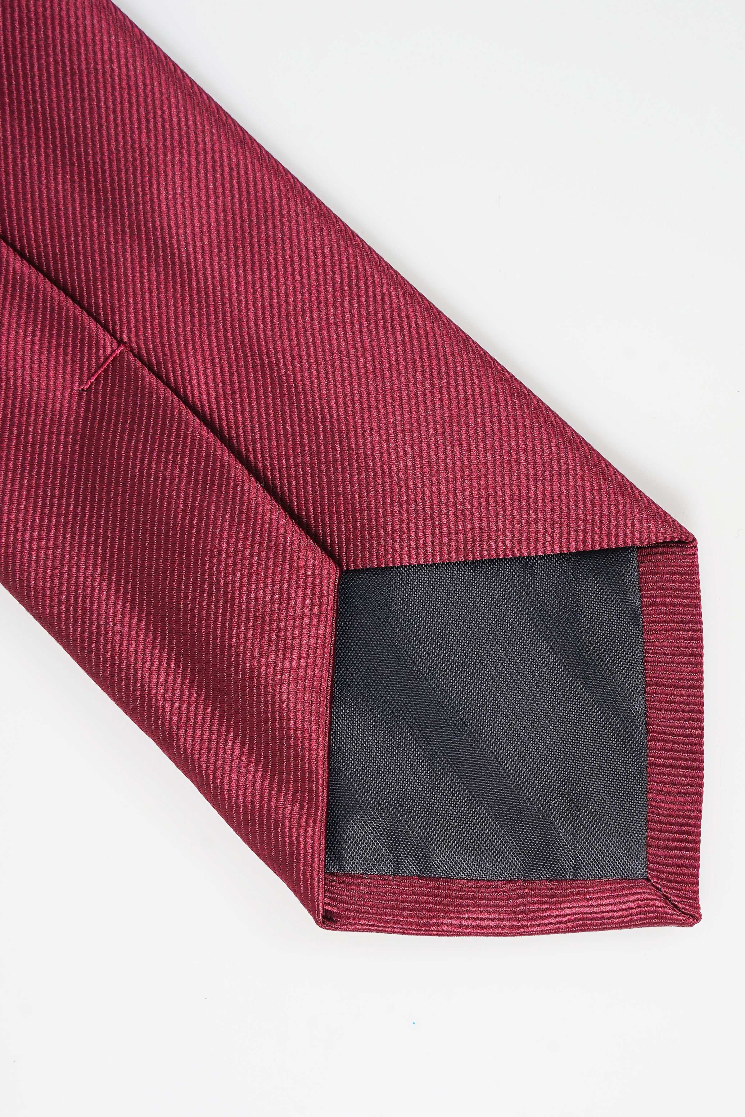 Maroon necktie with stitched seam and dark fabric lining at the tip