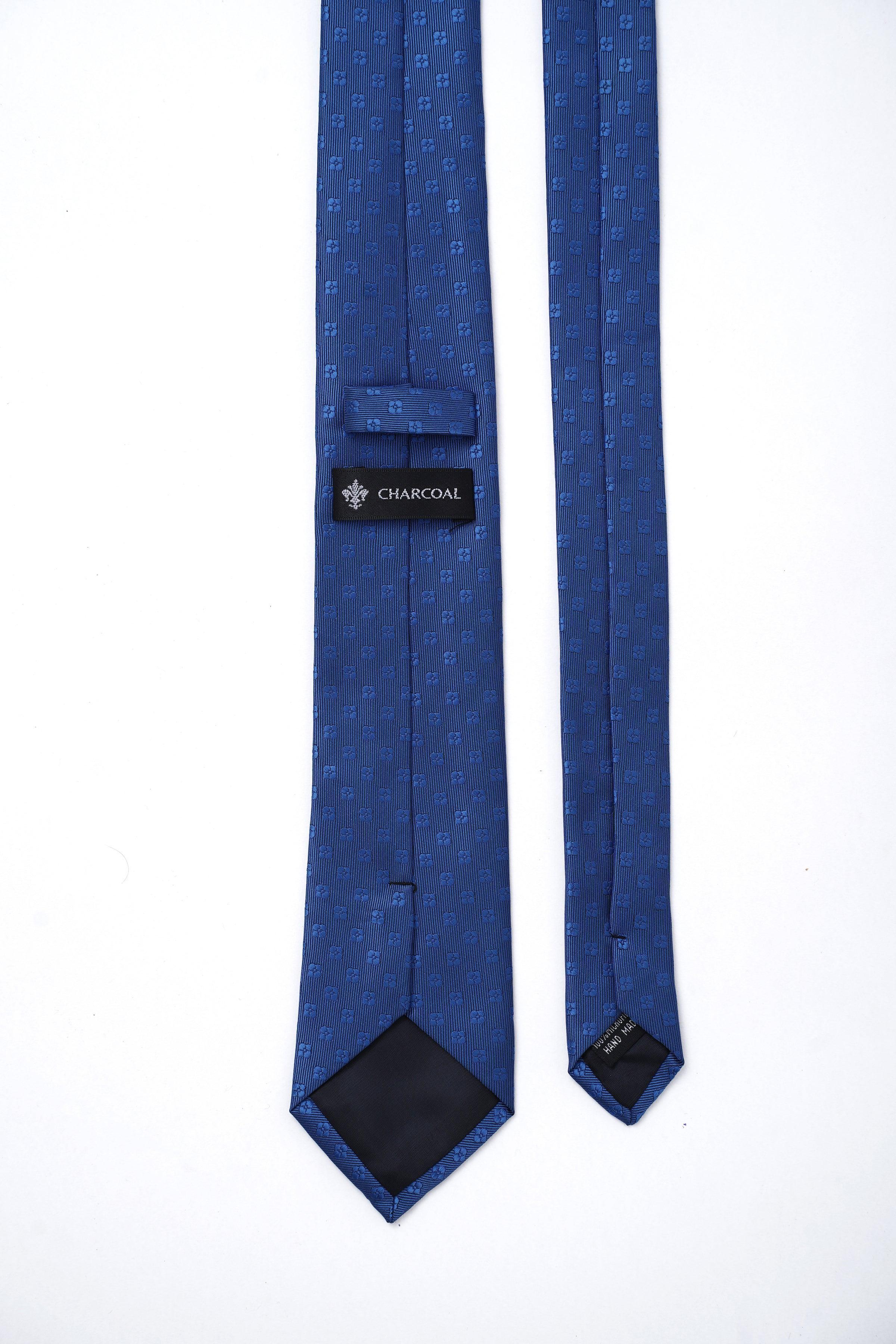 Navy blue necktie with interior label and patterned ends