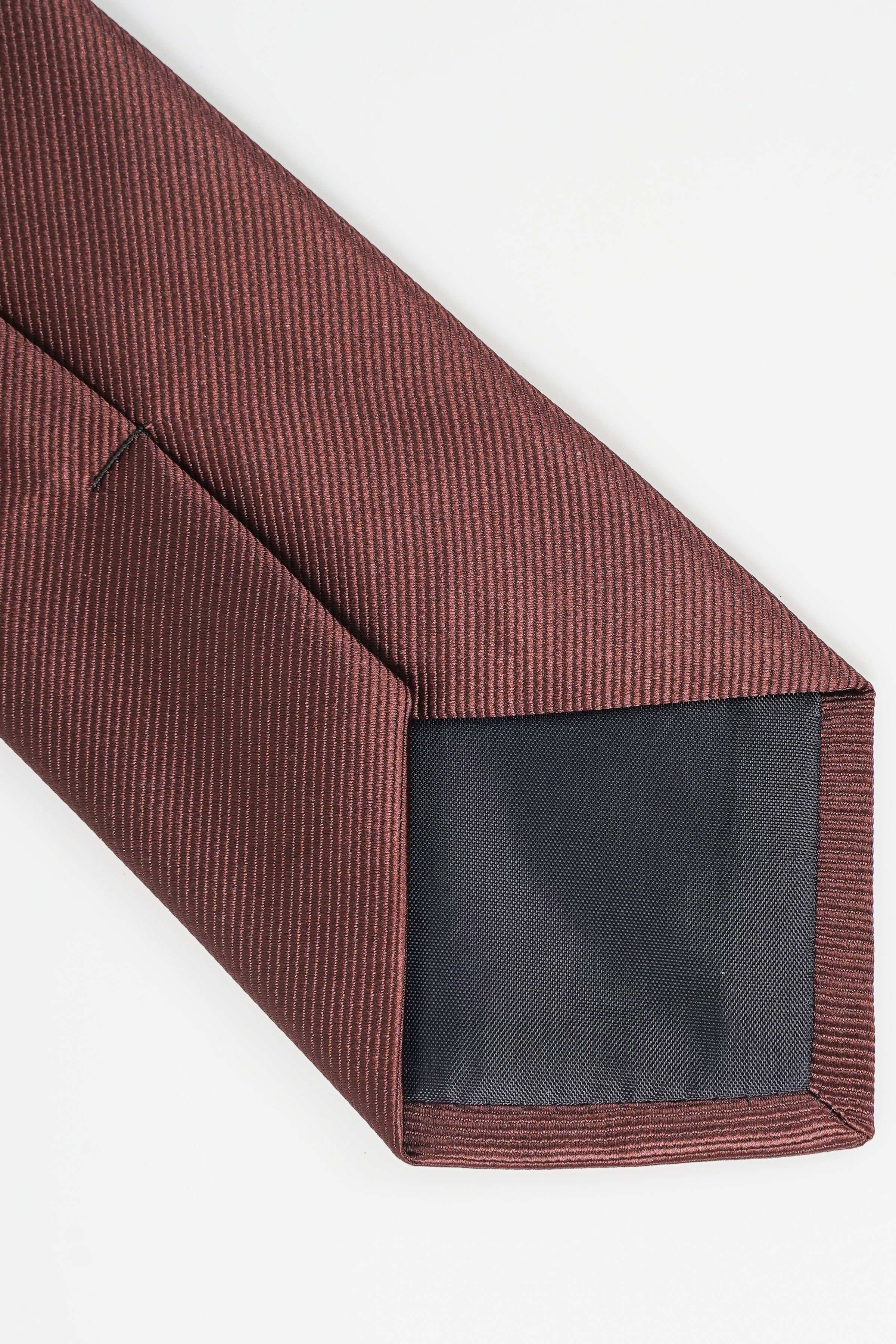 Poly silk necktie, burgundy textured weave, close-up of pointed end.