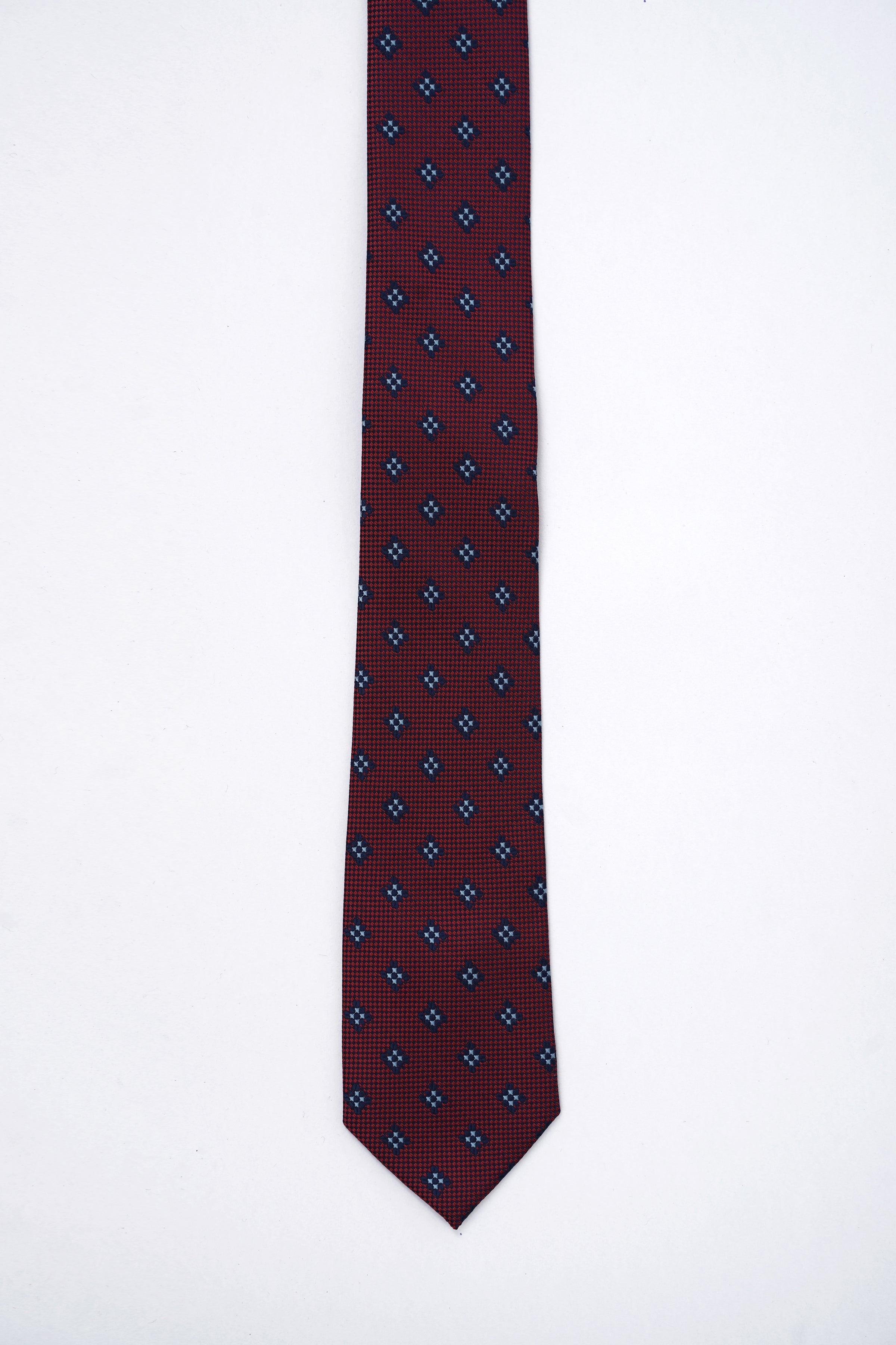 Poly silk tie in burgundy with navy geometric repeat pattern