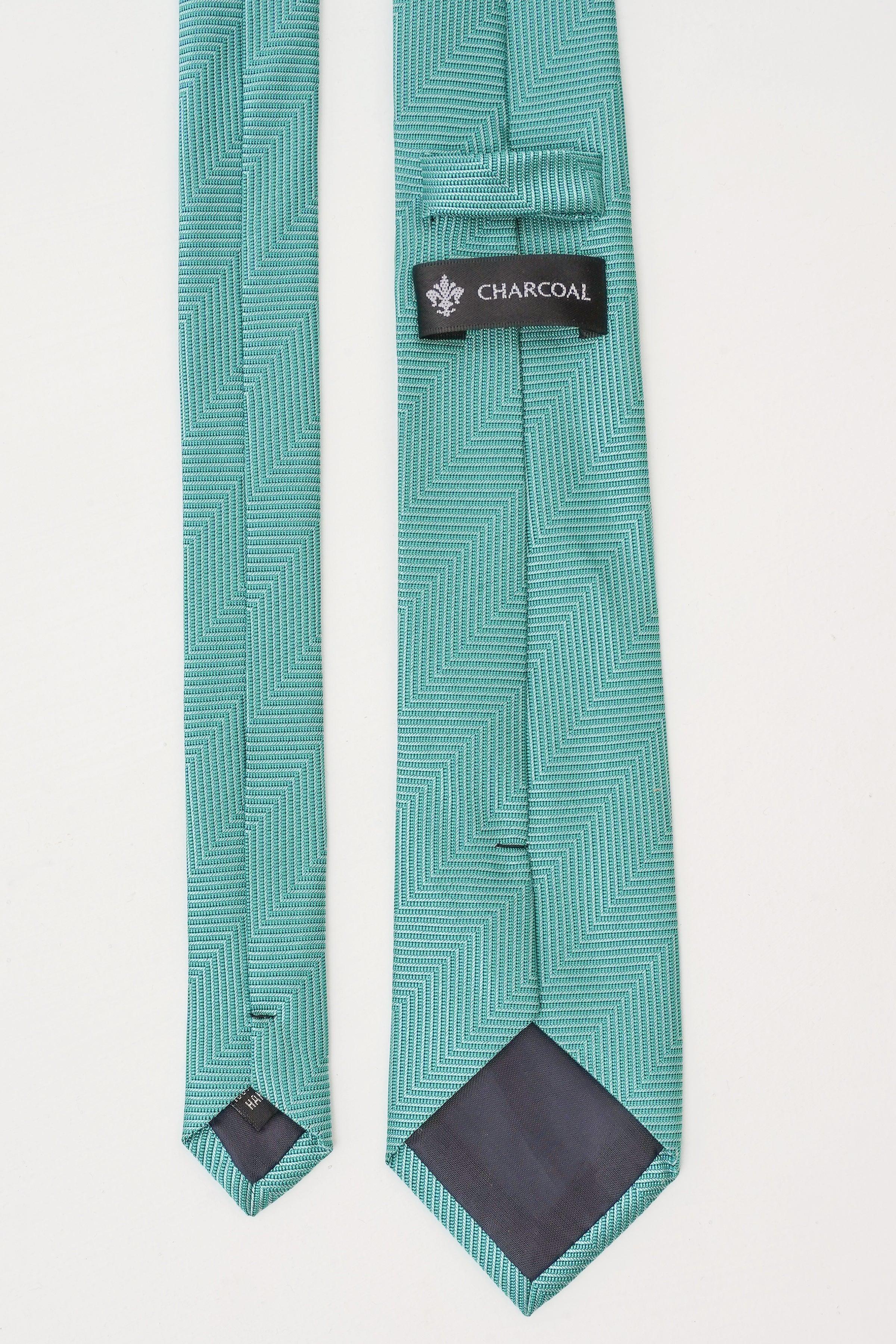 Turquoise poly silk tie with chevron pattern and charcoal label on the fold