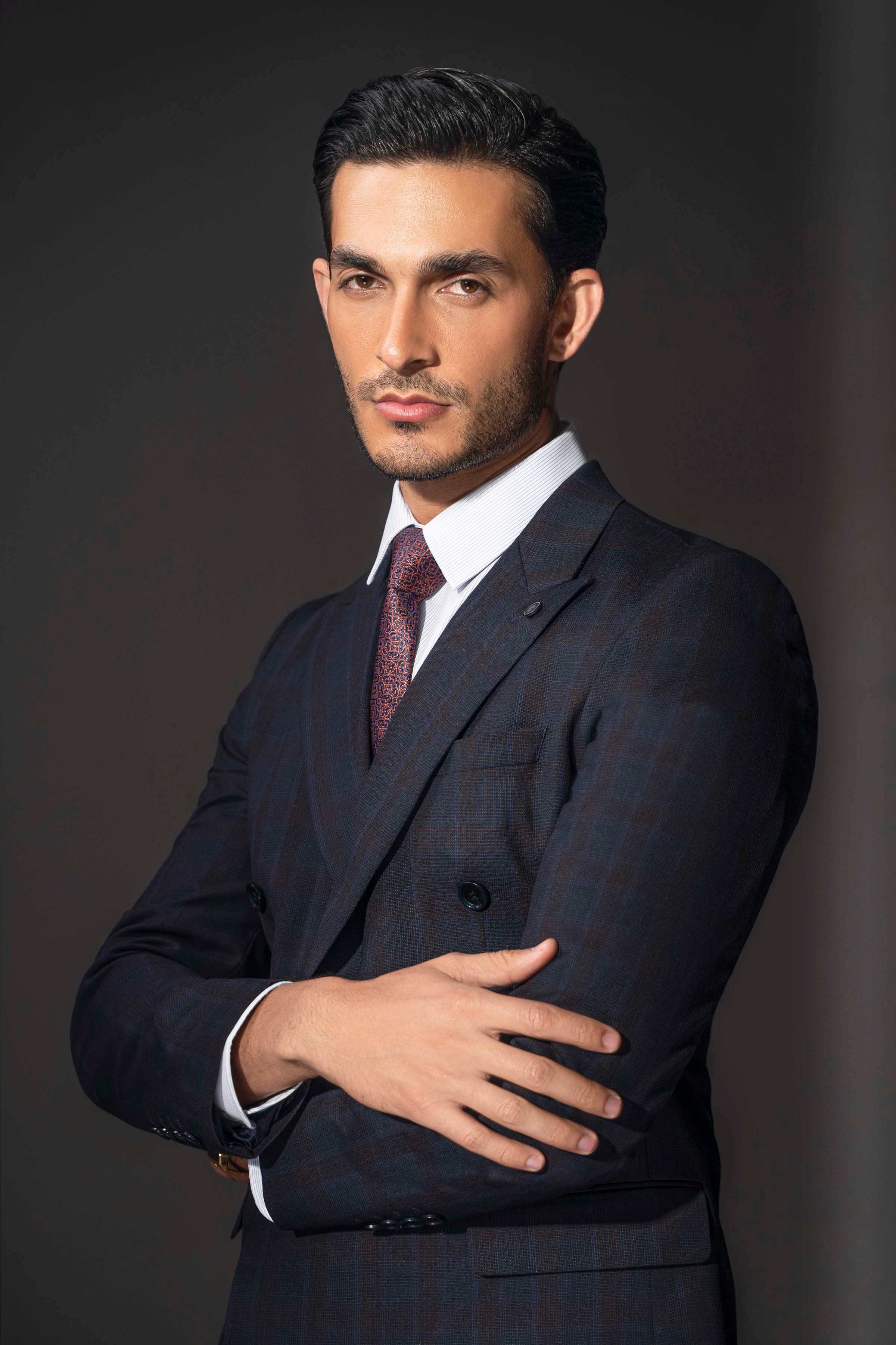 Navy check suit jacket with white shirt and burgundy patterned tie