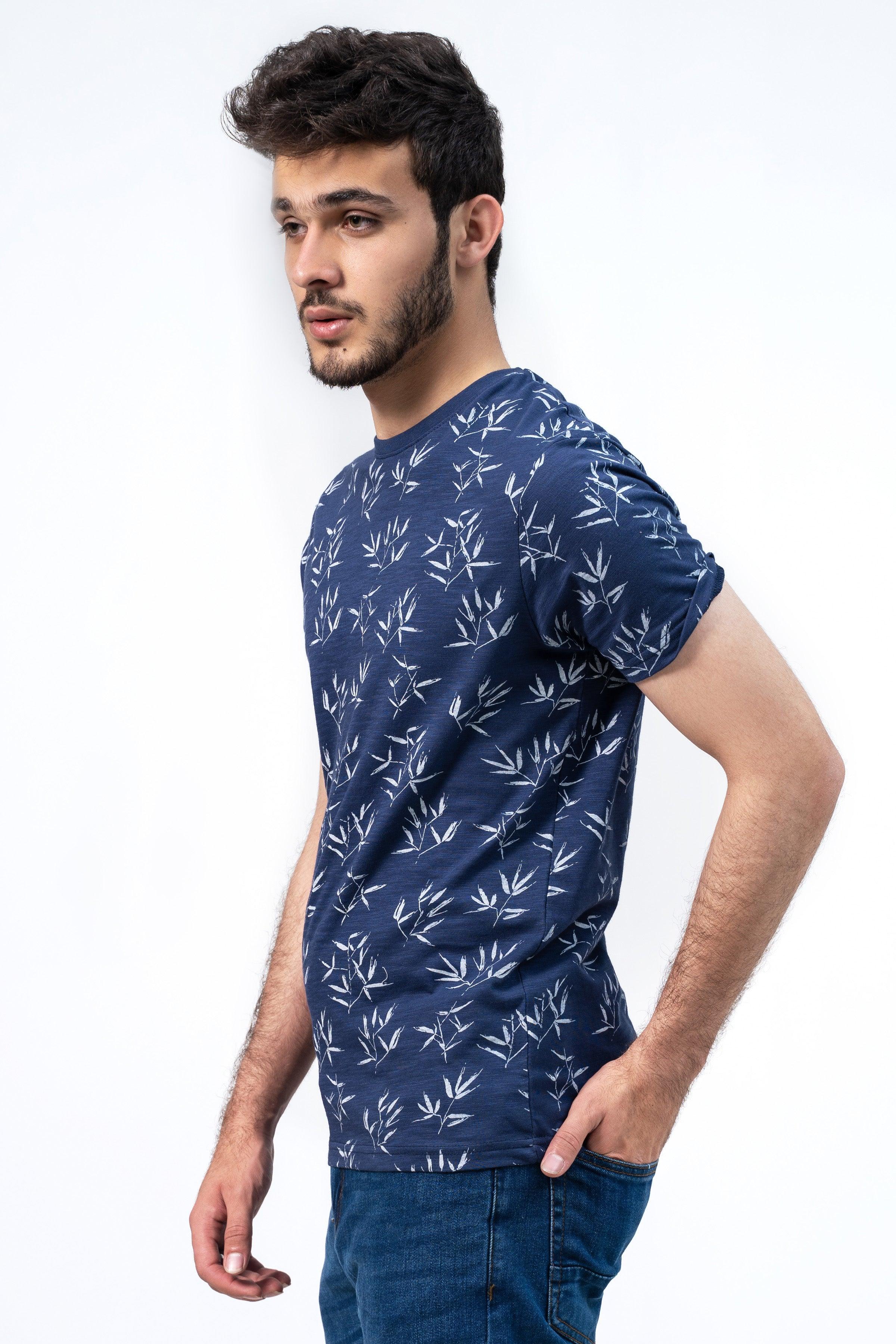 Men's navy printed T-shirt with white leaf pattern, side view, crew neck