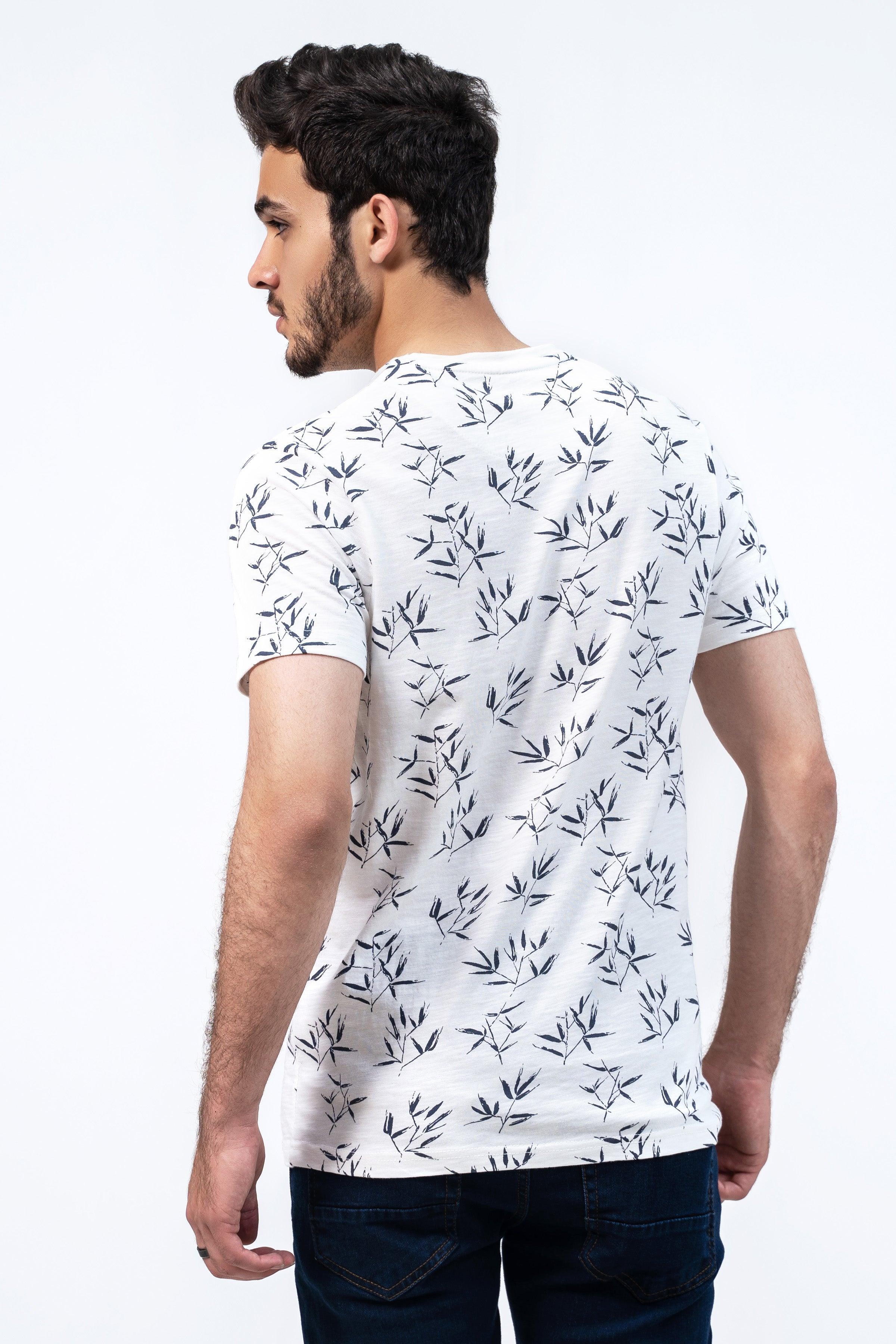 Off-white printed T-shirt with dark leaf pattern, back view, short sleeves