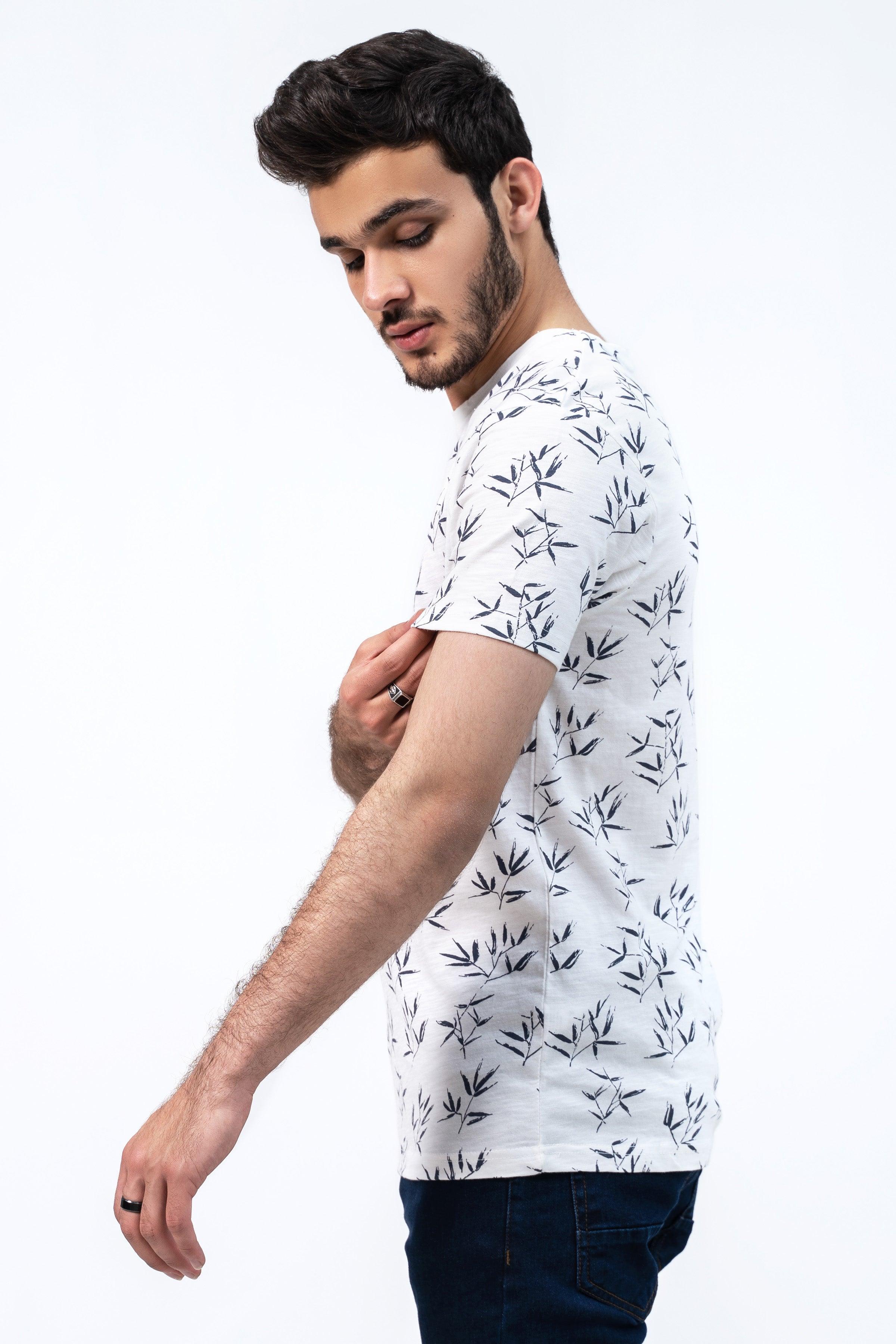 Off-white printed T-shirt with dark leaf pattern, side view, short sleeves